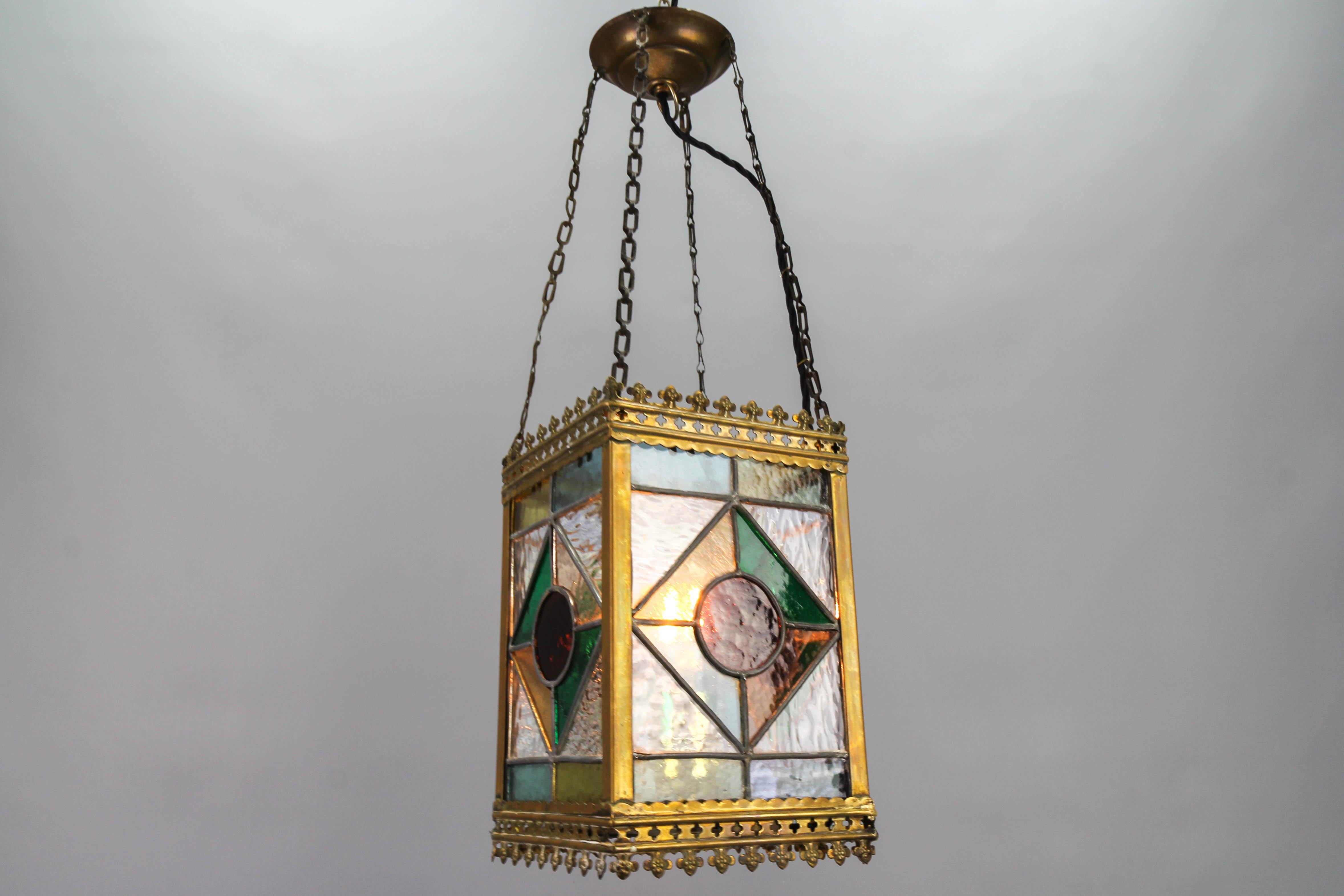 This delightful Victorian Gothic-style stained glass hall lantern is an ideal lantern for lighting in the entrance hallway. It is an antique, later electrified square lantern from the 1890s, probably Germany, with a geometric pattern that features