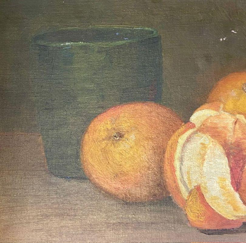 Late 19th Century Still Life with Oranges, circa 1900, an oil on artist's board in the Arts and Crafts manner, unsigned, a still life painting with three oranges, one half peeled and split into sections, with a black earthenware vase in background.