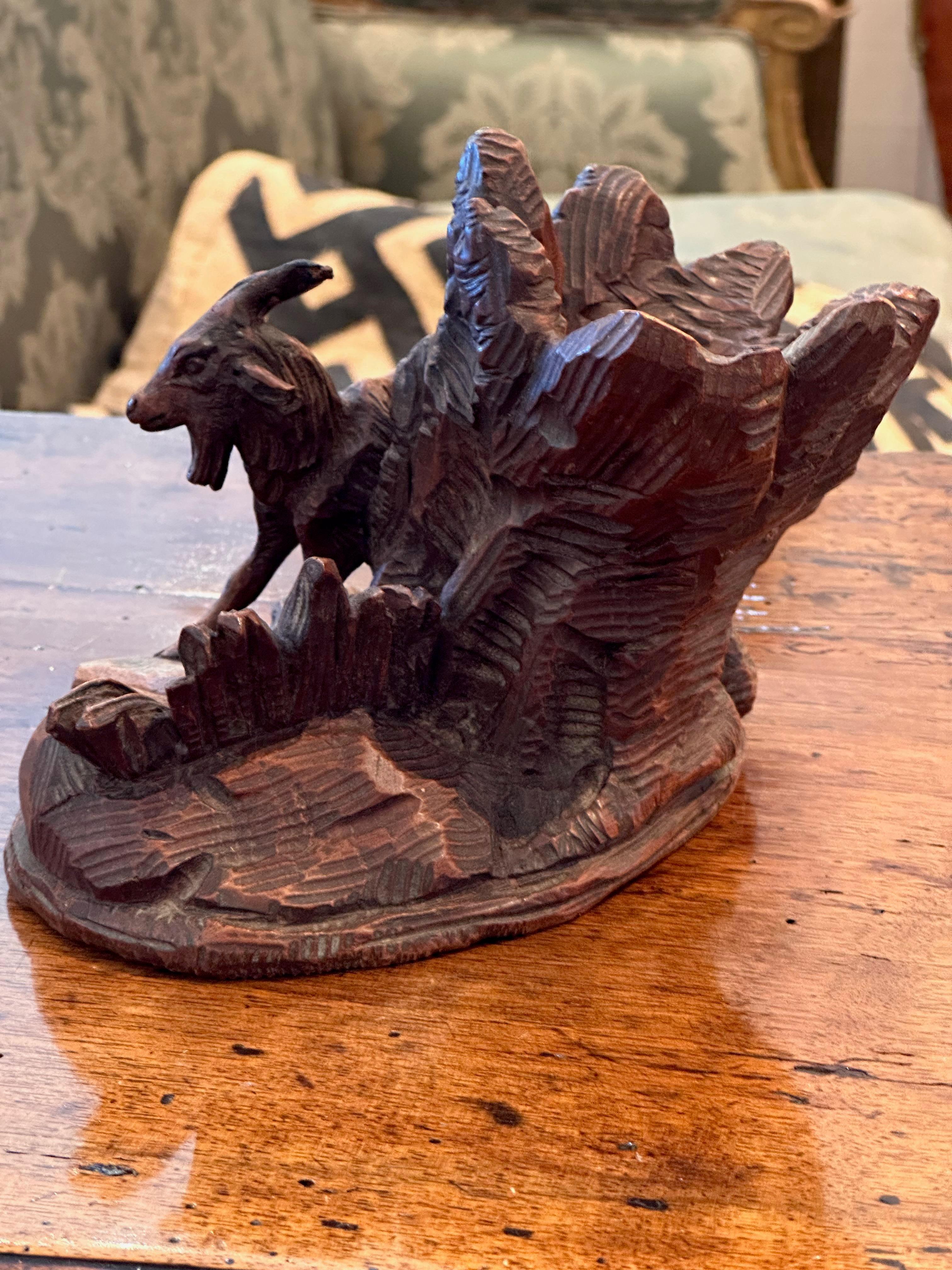 A carved piece with a goat