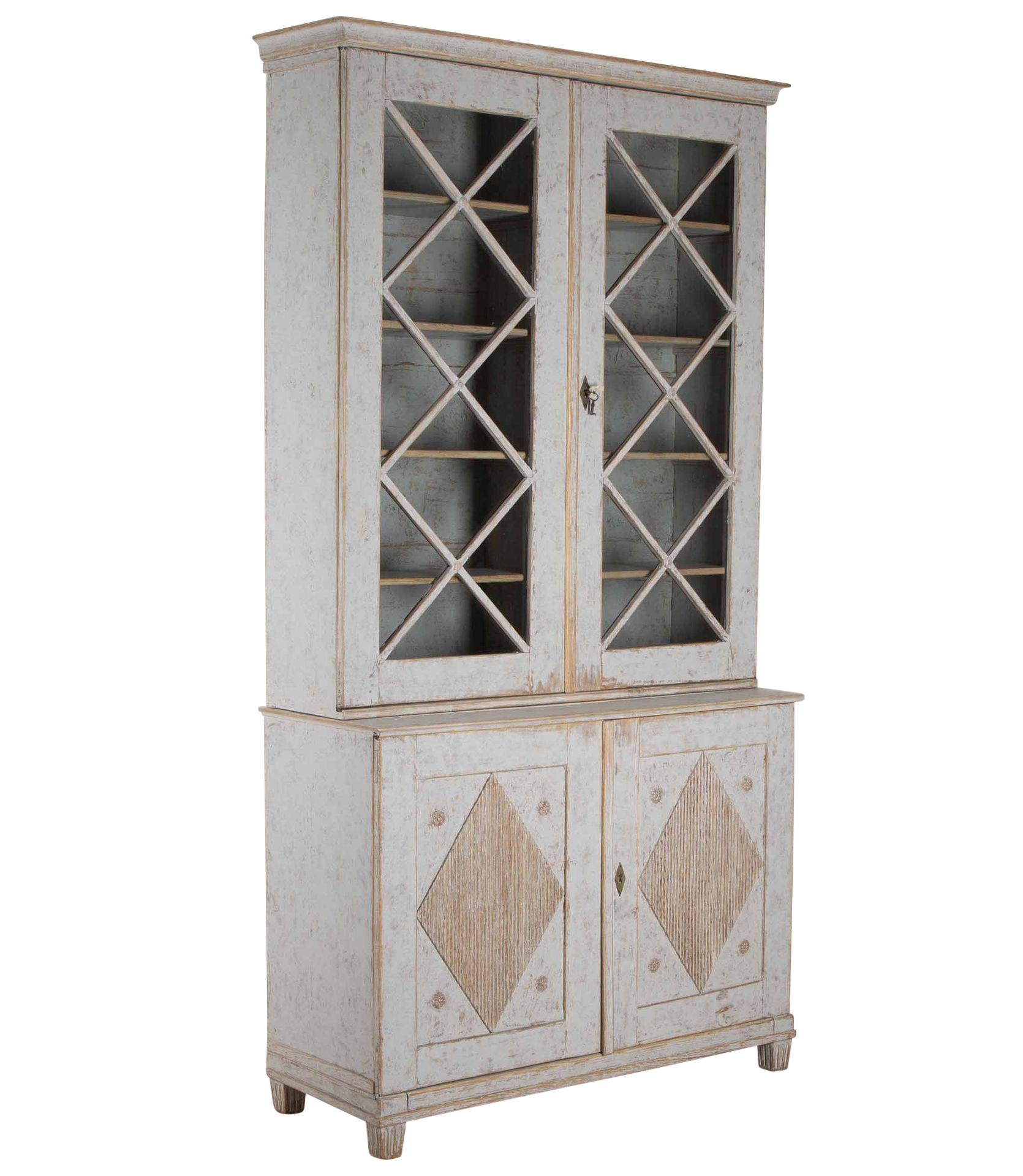 Late 19th Century Swedish Gustavian bookcase.
With two astral glazed doors, opening to storage shelves. Below two further doors, opening to more useful storage.
Repainted in soft grey. 