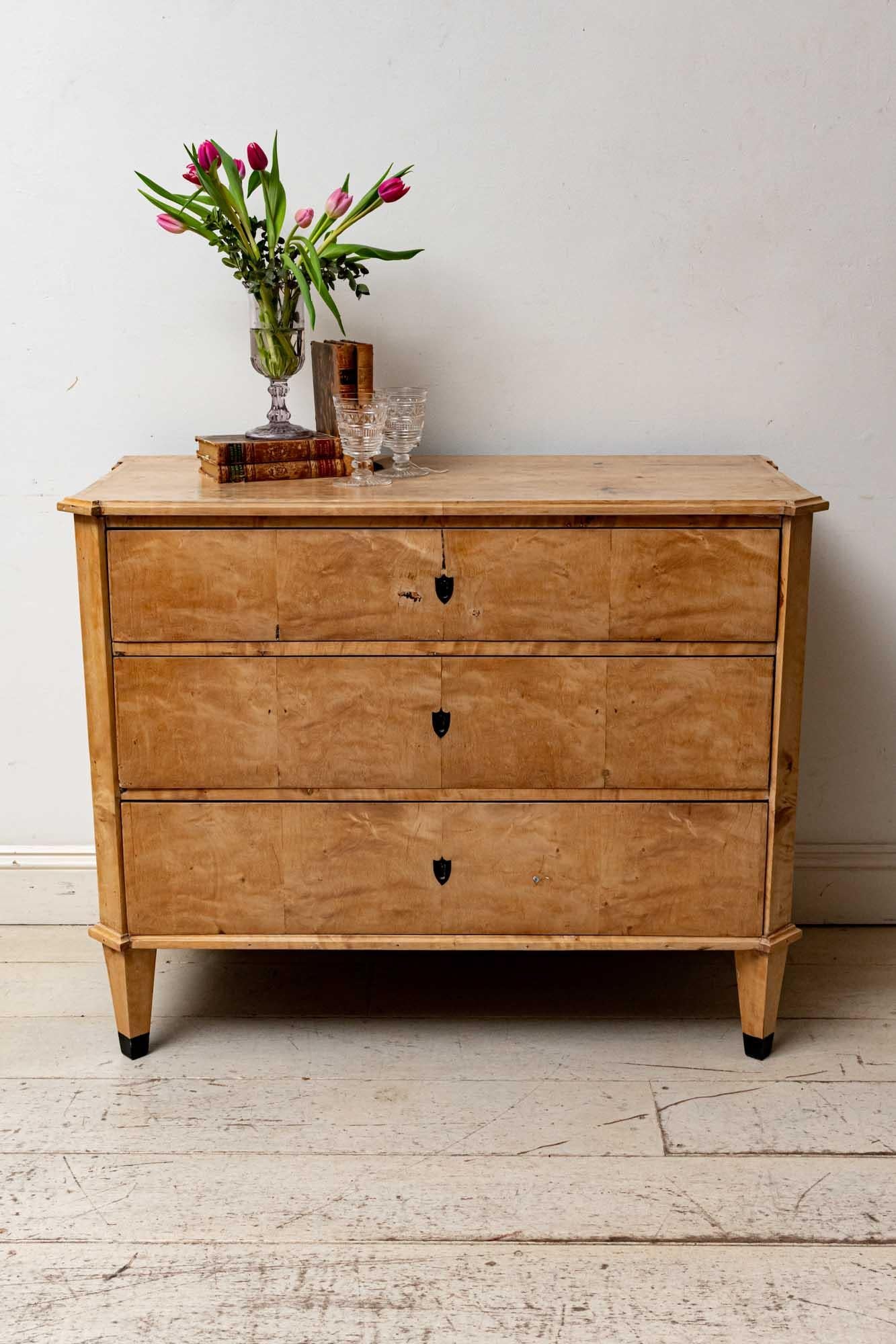 Late 19th century Birch commode comprising of three sliding drawers with their original keys and locks. The commode features a lovely pale coloured patina. A simple shaped design and form which would also work well within a more contemporary setting