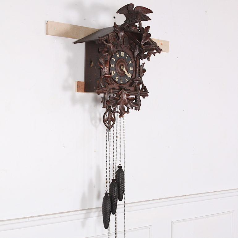 A late 19th century Swiss cuckoo clock with finely carved ‘Black Forest’ type carving and an unusually complicated movement. Two birds chime- one on each quarter and the other sounds the hour count on the hour. Weight driven with one weight each for