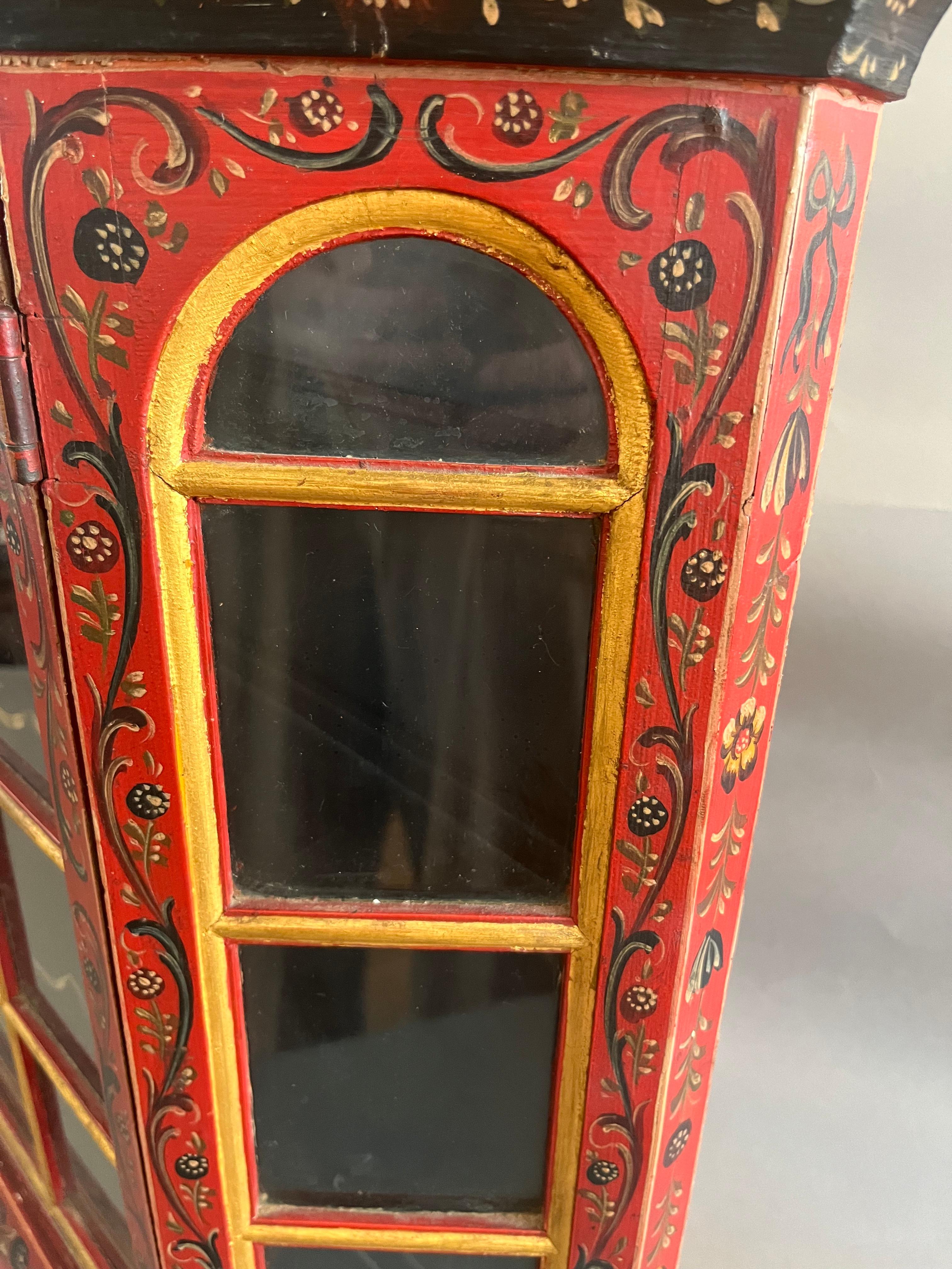 Late 19th Century Swiss  Provincial Painted Cabinet. Glazed sides and doors with shaped shelves between arched cornice. Made in Switzerland Circa 1890.