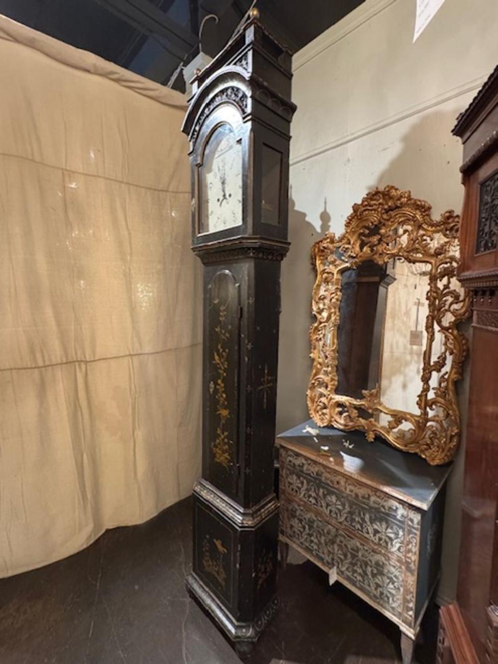 This Late 19th Century Tall Case Grandfather Clock with Chinoiserie Design is a stunning antique piece that adds a touch of elegance to any room. The intricate chinoiserie design on the clock face and tall case gives it a unique and charming