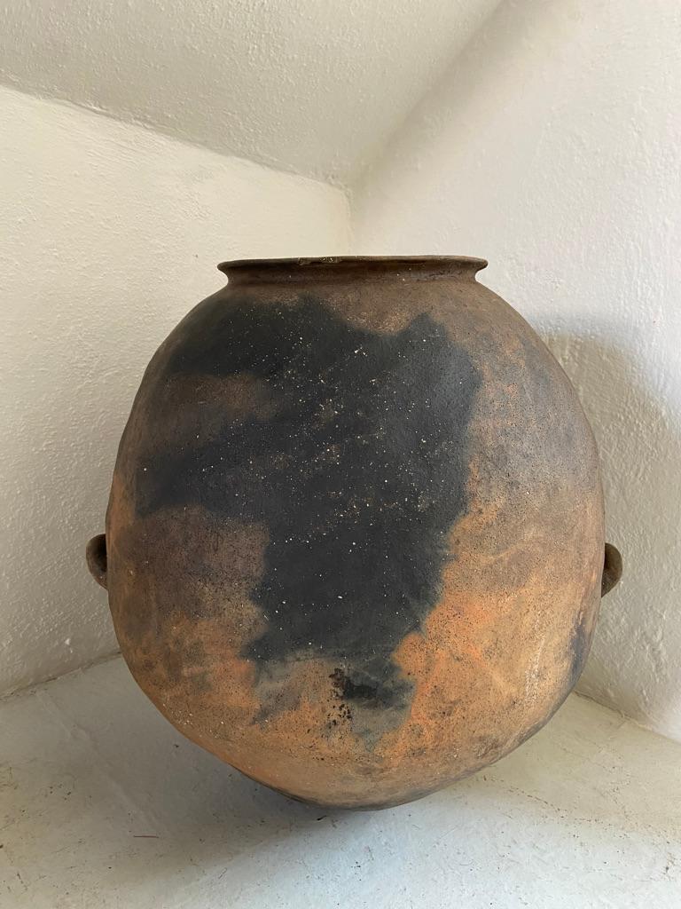 Terracotta water pot from the sierras of Northern Puebla, Mexico, late 19th century. Handles intact and structurally secured. Strong fire markings.