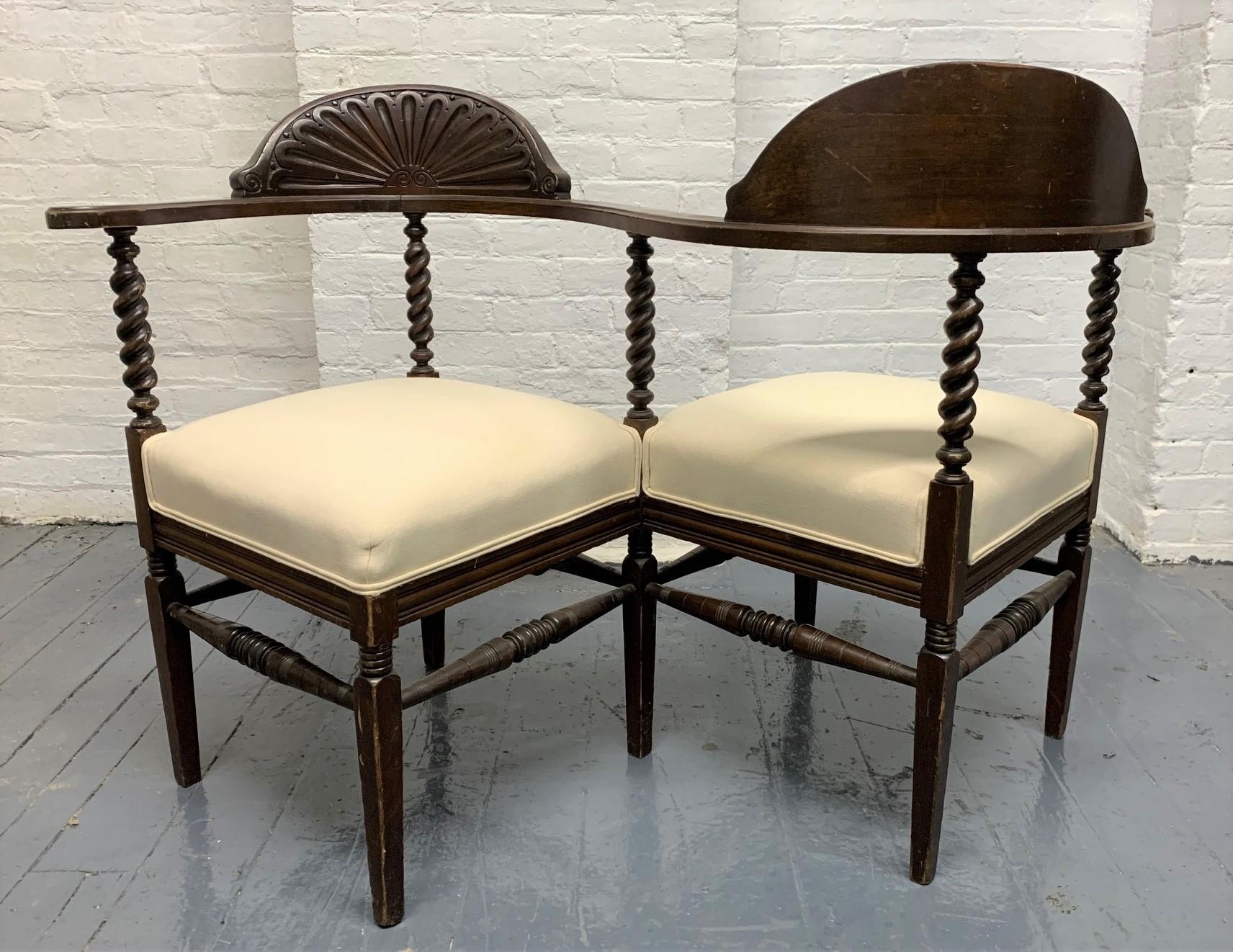 Late 19th century Tete a Tete with carved wood frame and an upholstered, linen-blend, cushioned seats.