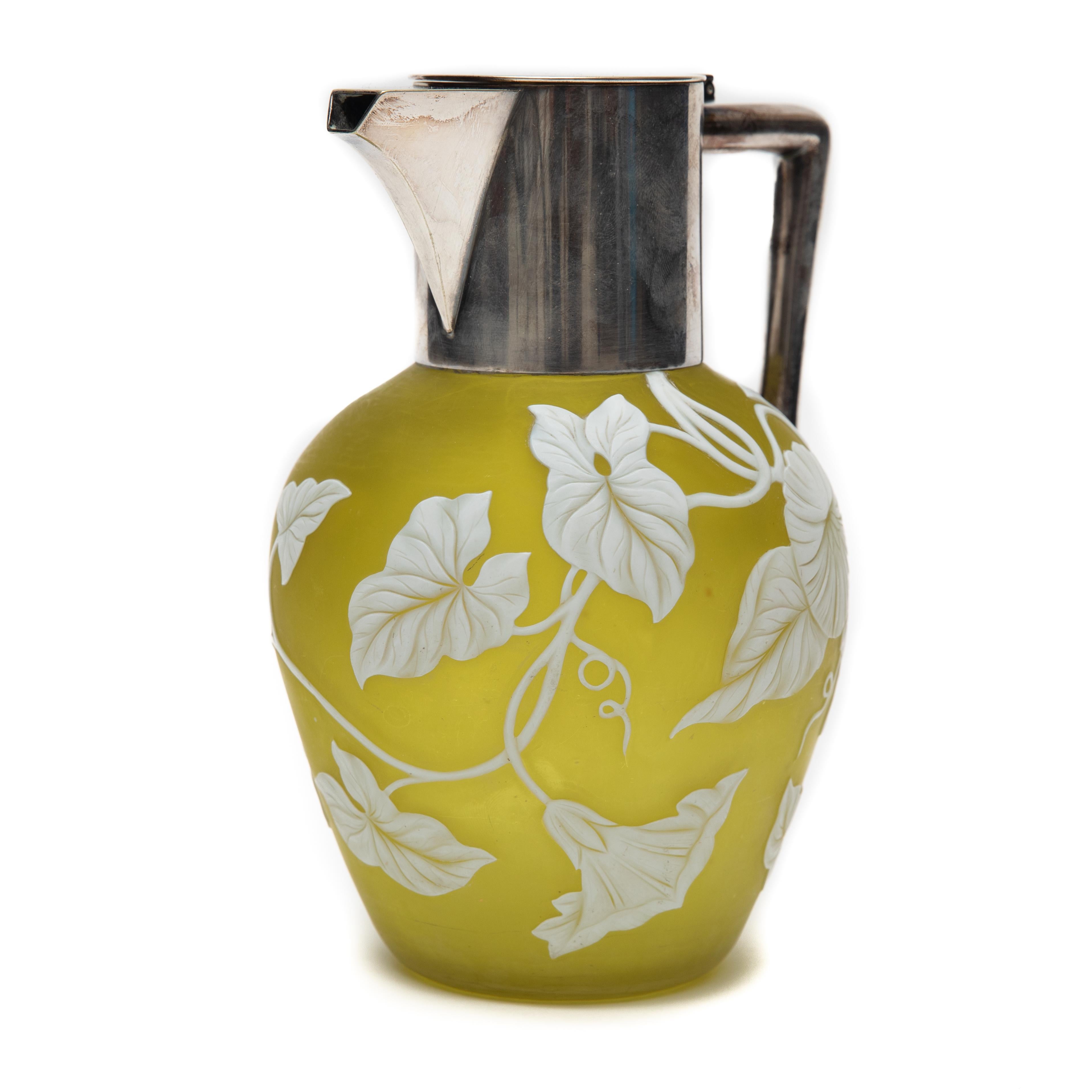 Thomas Webb & Sons Cameo glass jug with silver plated mount, late 19th century. The Jug depicts a long and trailing foliage pattern on a satin olive green ground. Marks: THOMAS WEBB & SONS 300. Measures 7-1/2