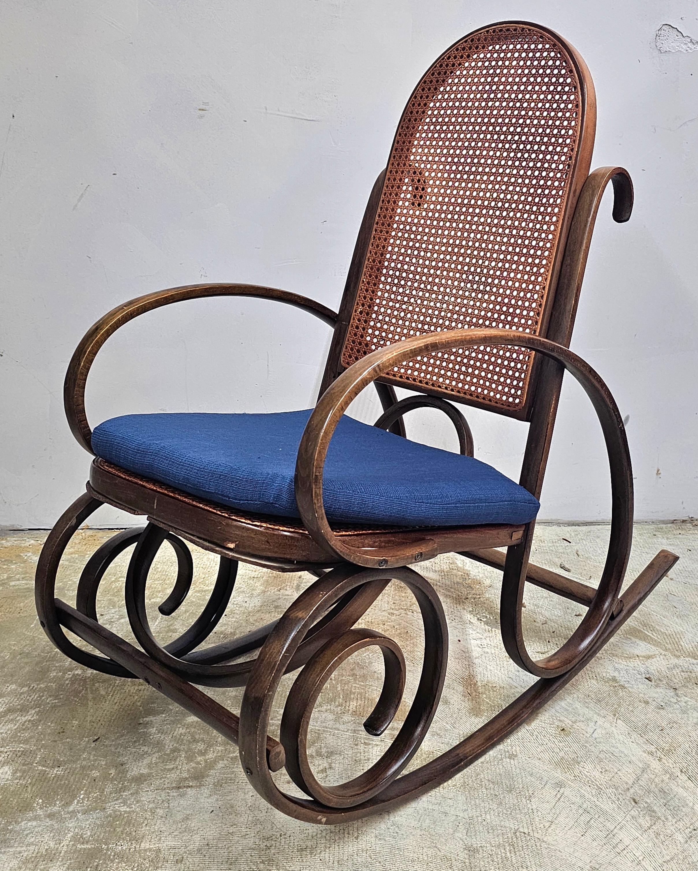 Late 19th Century Thonet #21 Bentwood and Cane Seat and back Arm Rocking Chair with blue cushion seat. Measures 18