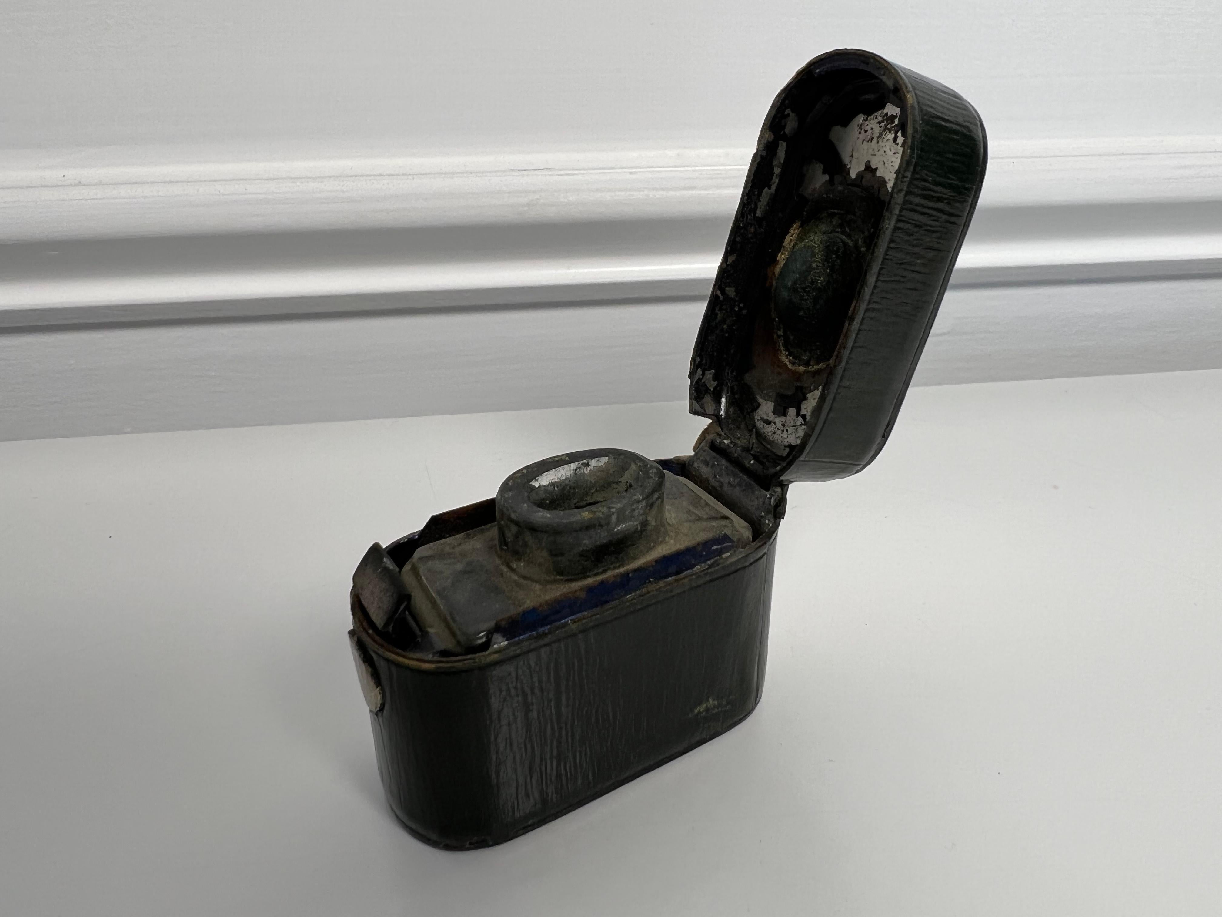 Late 19th century traveling oval leather inkwell with a glass interior well and a hinged lid. A nice pocket size inkwell, a great piece to be add to any collection. From a private collector who traveled the world buy unique and unusual pieces.