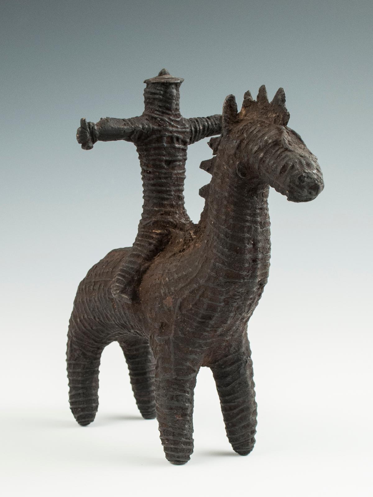 Late 19th century tribal cast bronze horse and rider, Kondh people, India

A bridal dowry sculpture in the form of a helmeted soldier riding a horse, he having the reins in one hand and a small weapon or symbol of authority in the other. Metal