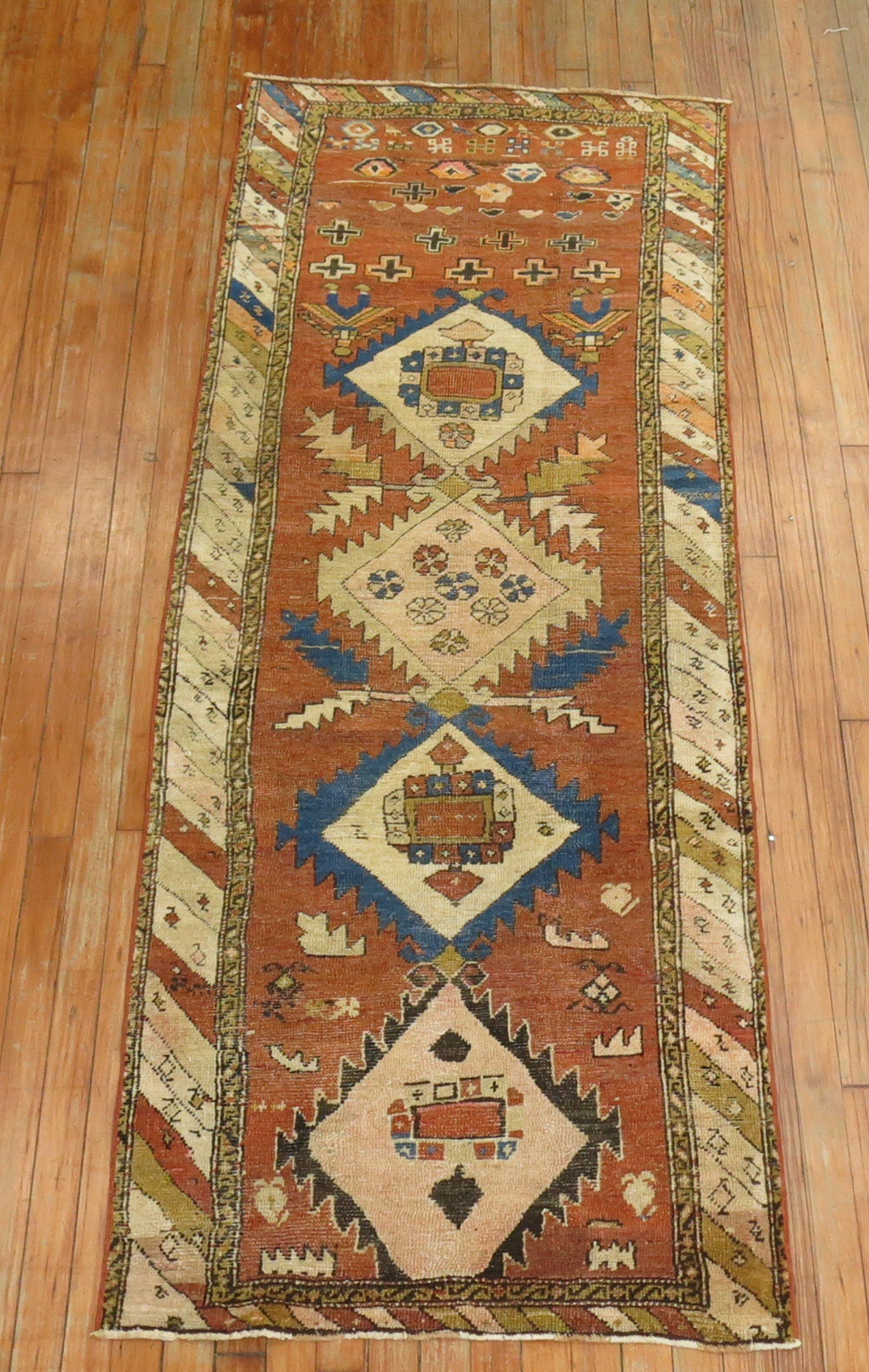 A late 19th century tribal Northwest Persian runner with rustic colors in denim blue, brown, brick,

circa late 19th century, measures: 2'4