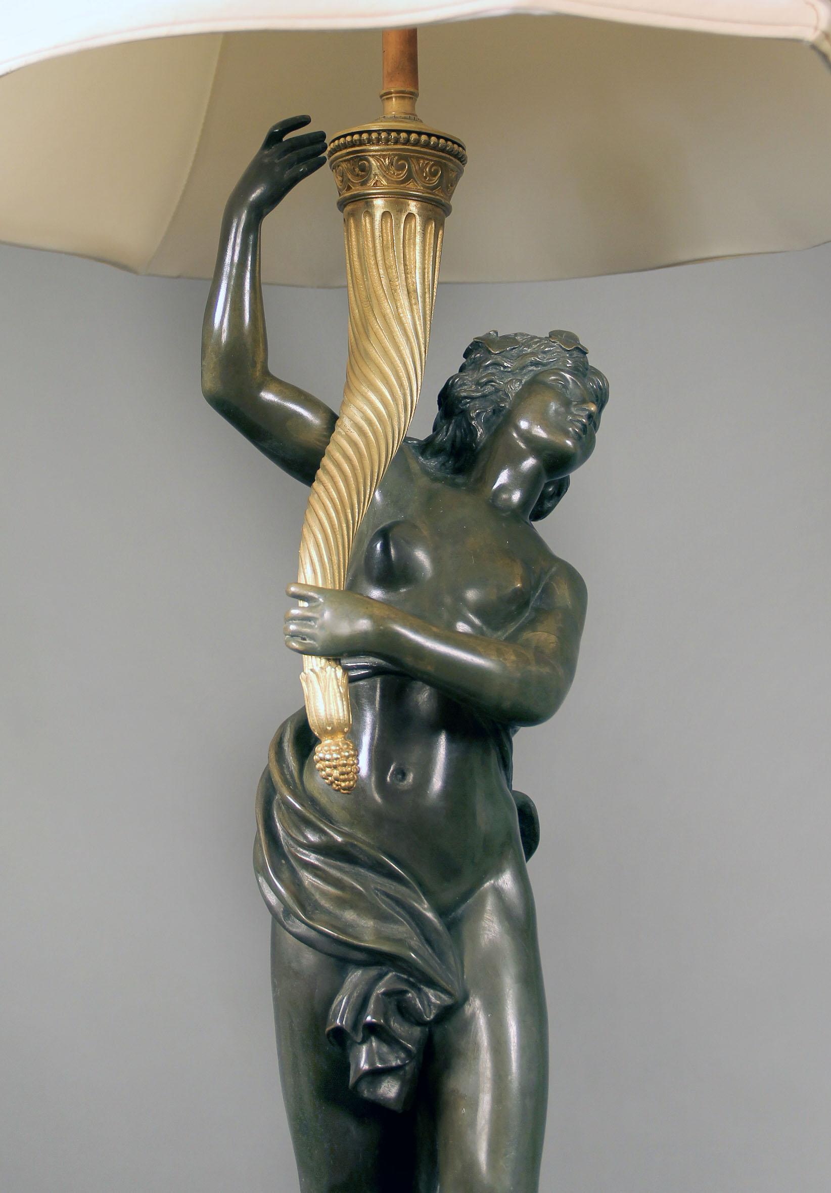 A late 19th century two-tone bronze lamp

After Clodion

Cast as a female figure from a bacchanale upholding a cornucopia lamp, on a bronze-mounted circular marble base. 

Claude Michael Clodion, [1738-1814], was the son-in-law of sculptor