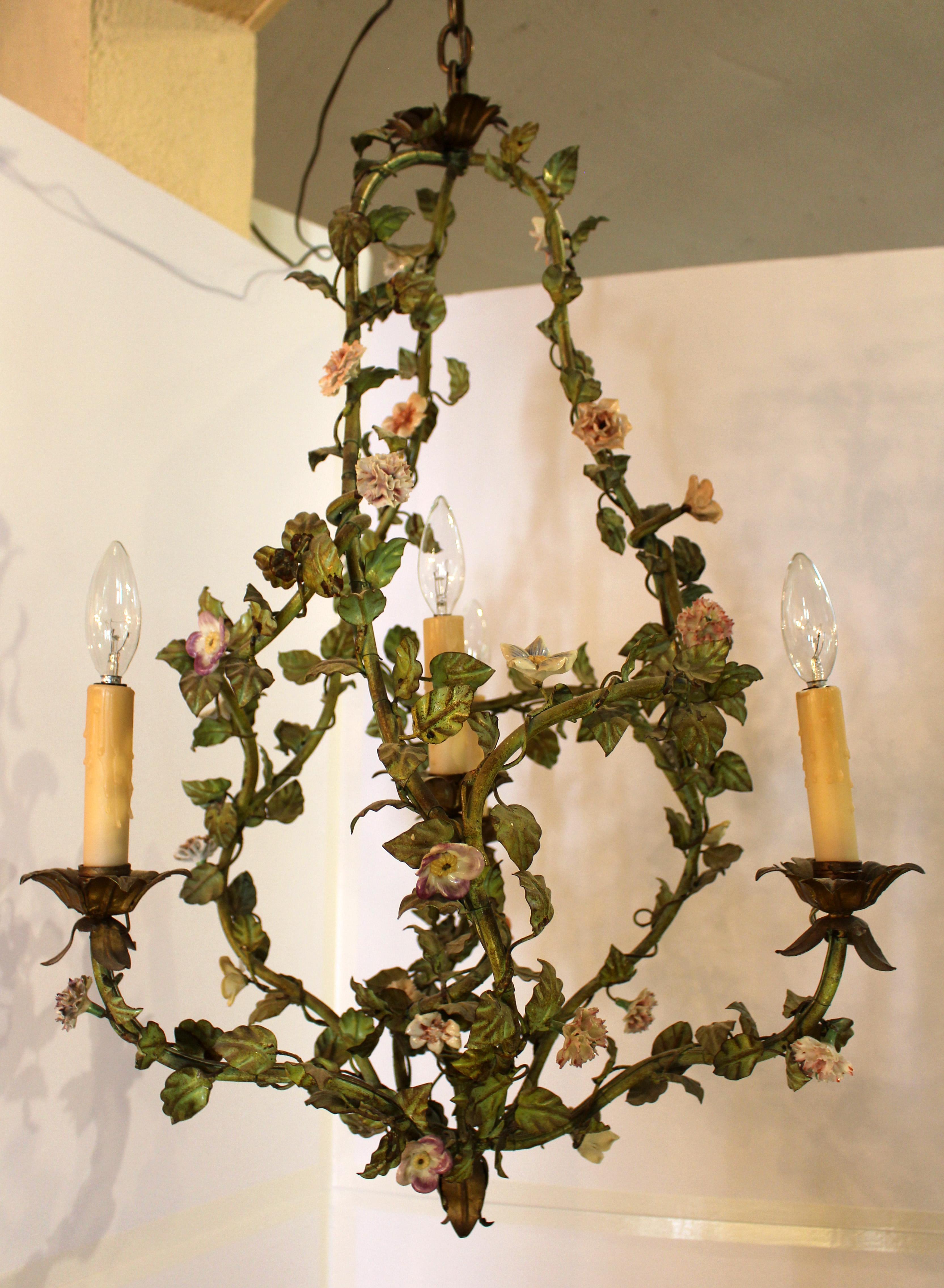 Verdigris tole 4-light chandelier, late 19th century, asymetrical Rococo design, French. The whole elaborately entwined in metal leaves with porcelain flowers and gilt acanthus leaf details. Provenance: Marvin Alexander, NYC 8/10/00