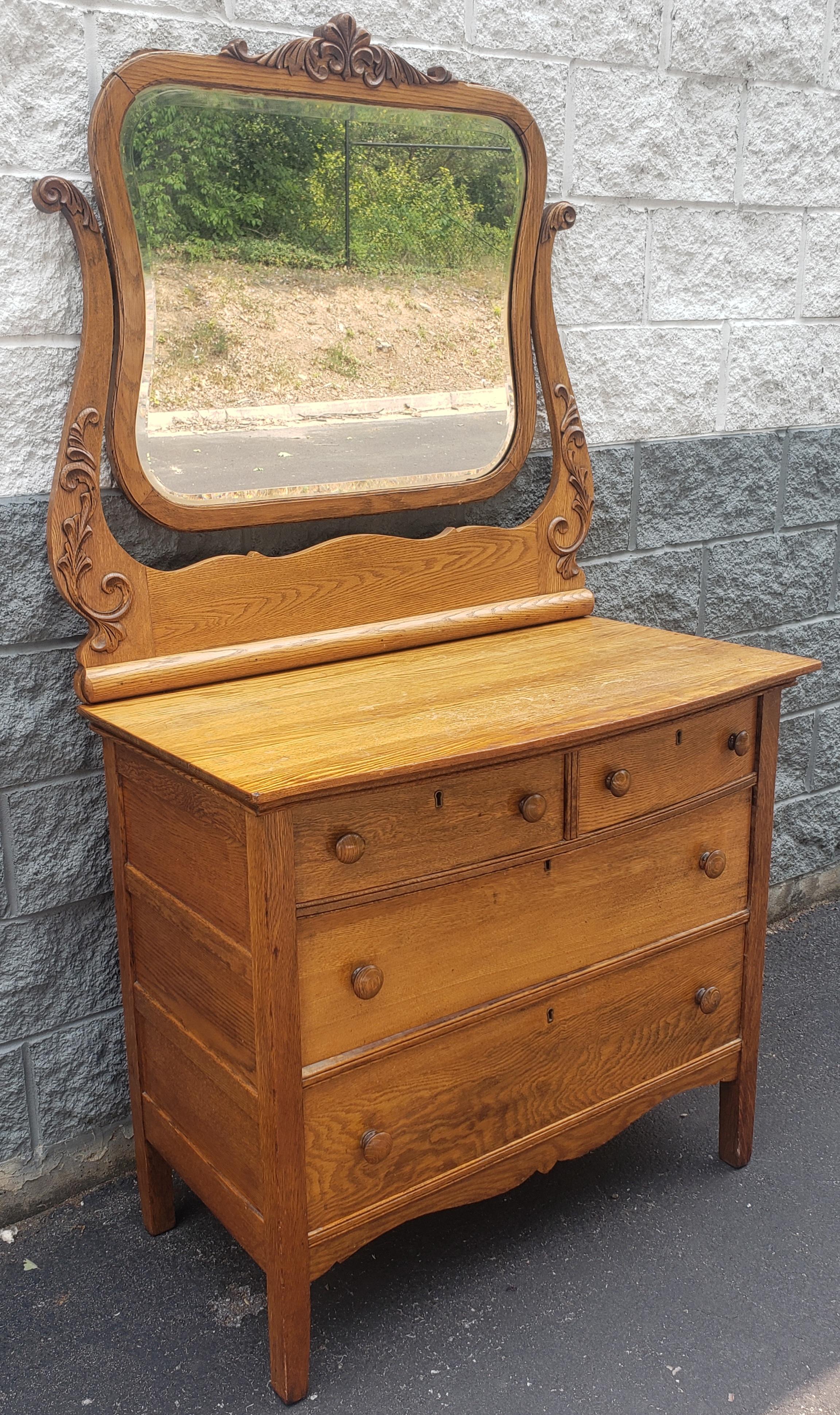 A Late 19th century Victorian Carved Tiger Oak Dresser with Mirror. Good condition. Measures 38