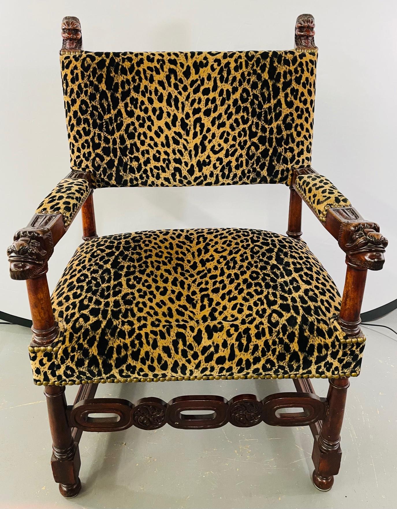 A rare late 19th century Victorian gothic revival chair. The chair is made of solid mahogany skillfully carved in gothic motifs featuring figural design on both arms and on each side of the back of the chair. The chair features leopard upholstery