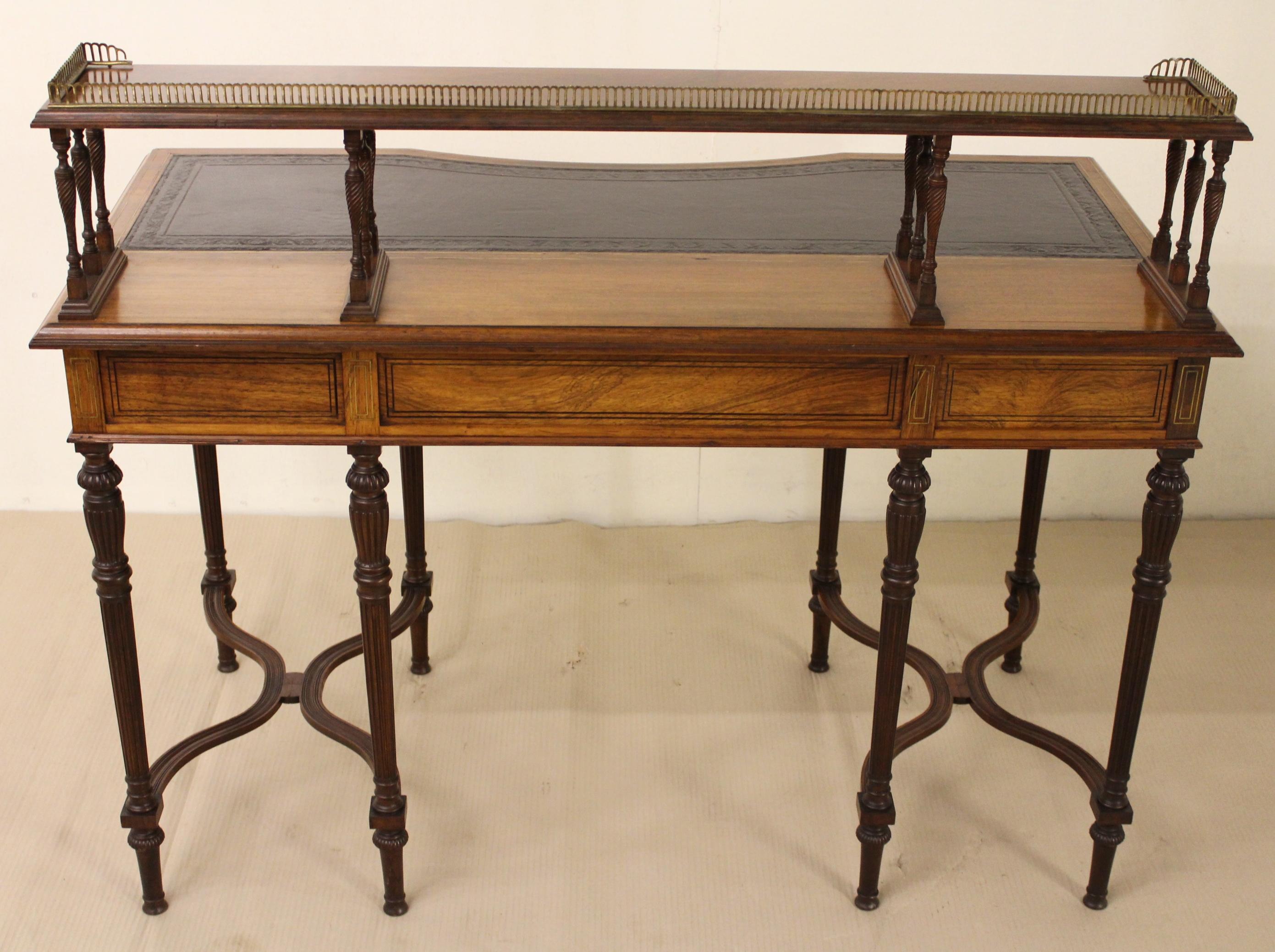 A very fine quality writing table by the prestigious London firm of cabinet makers, Collinson and Lock. Made in the third quarter of the 19th century with Regency style influences. Of excellent construction in rosewood and attractive rosewood