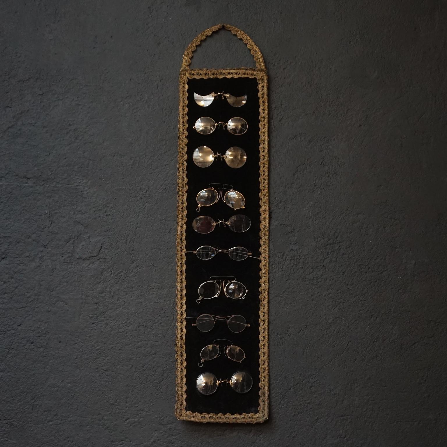 Very pretty Victorian set of shop or salesman sample glasses sewn on a cardboard and velvet panel

10 different sizes and models of eye glasses
8 of them are so called Pince-Nez glasses with different 'nose pinch' systems 
2 of them have 'legs'.