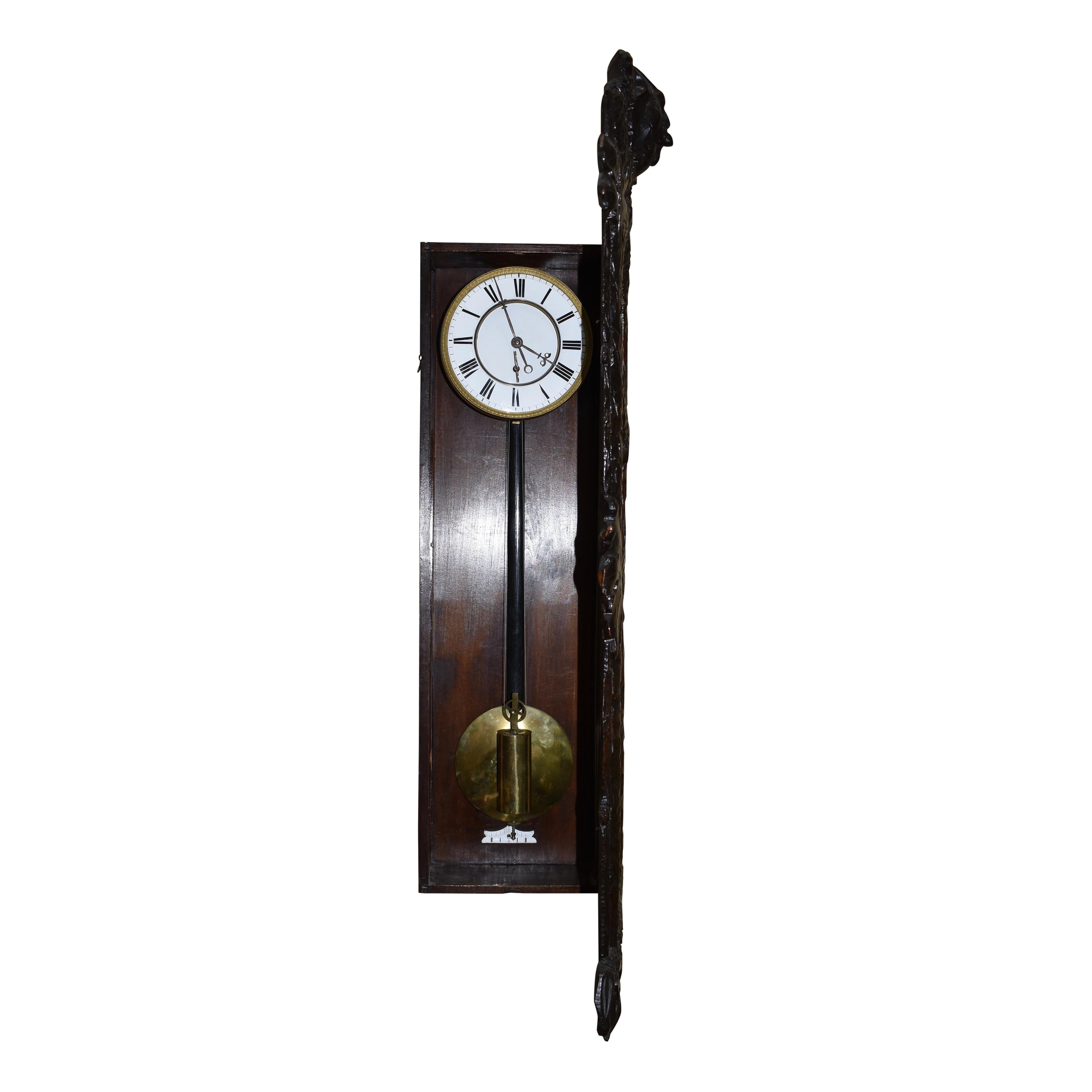 Late 19th century Vienna regulator single weight wall clock in a carved walnut and glass case. Because of the style of case, which is unlike most cases made in Austria, it is likely the case was carved in Germany or Switzerland and then fitted with