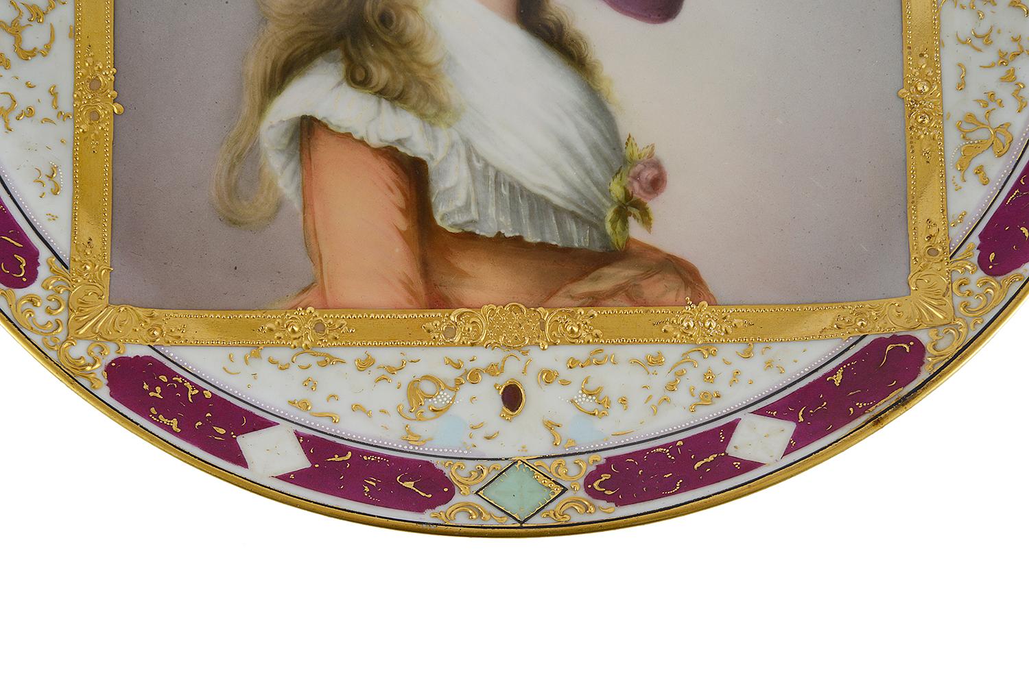 A very good quality late 19th Century Austrian, Vienna style porcelain plate, having classical gilded and burgundy boarders with an inset hand painted portrait of the 