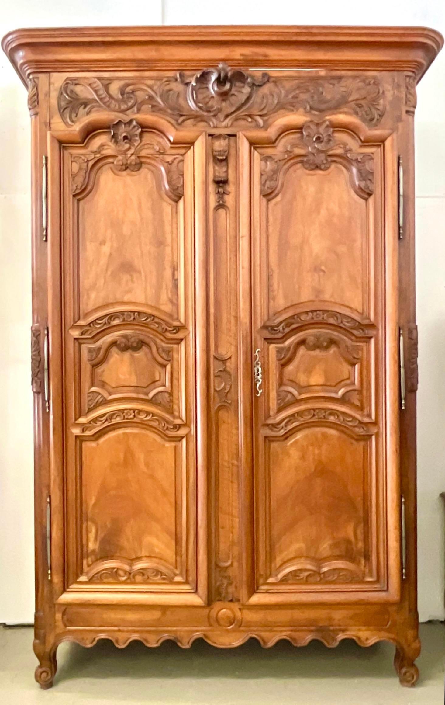 An extraordinary vintage Boho armoire. A hand carved piece with beautiful attention to detail. Monumental in size and drama. Fully lined in a slub linen. Can be used as an entertainment center or add the coordinating shelves to use it for storage.