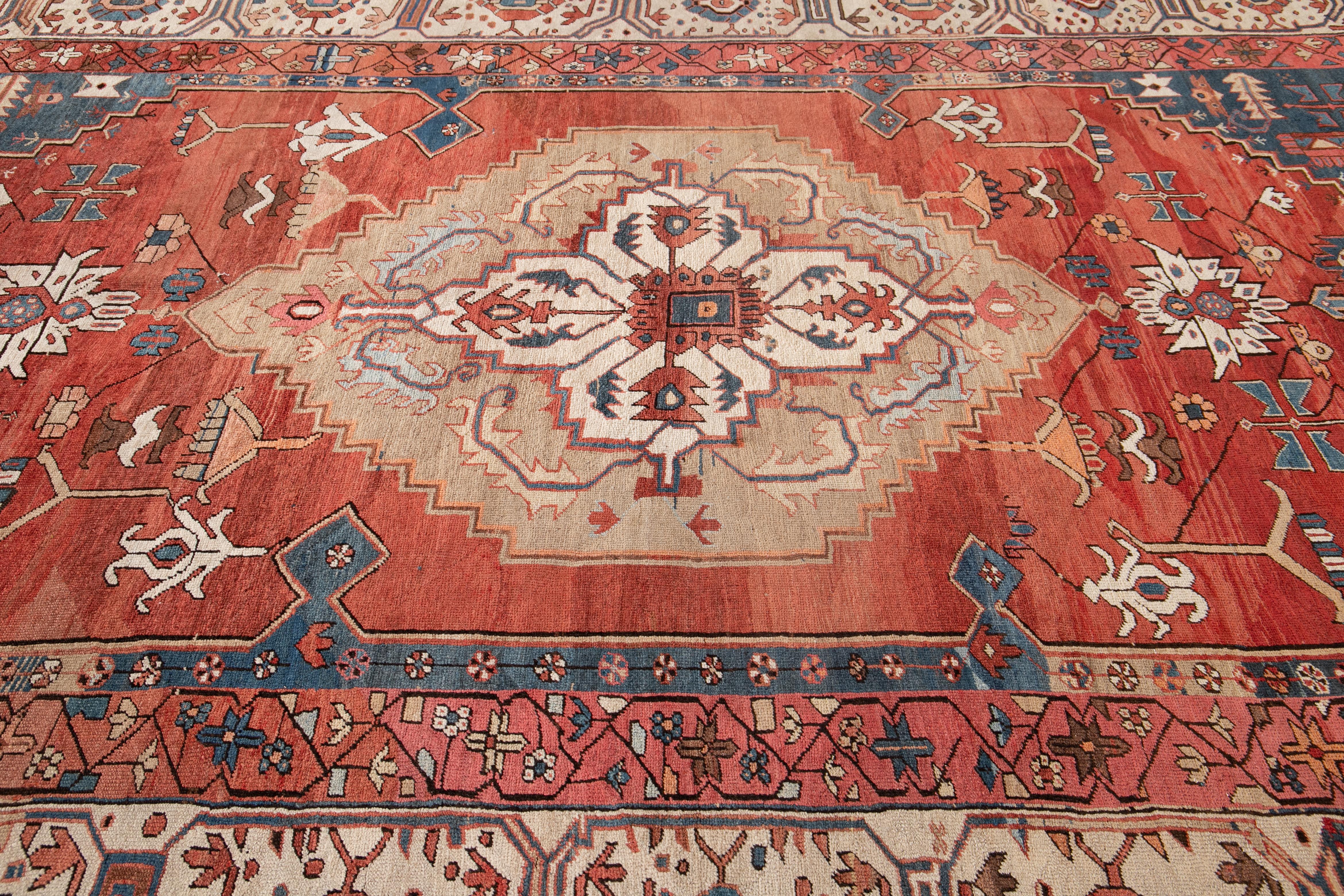 Beautiful antique Serapi rug, hand knotted wool with a rust field and blue and beige accent with a center medallion design,
circa 1890s
This rug measures 9' 7