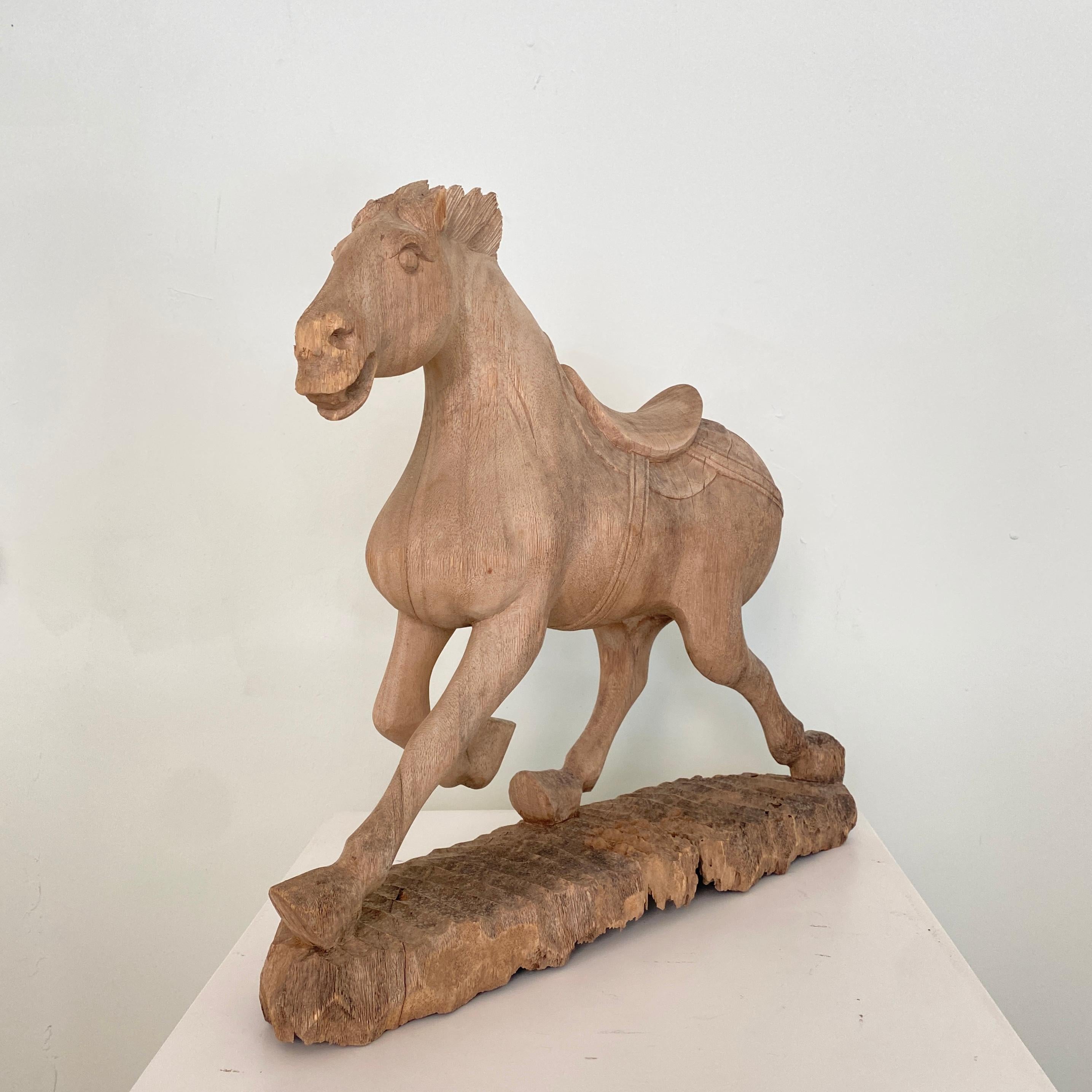 This late 19th century Chinese carved wooden tang horse was made and carved around 1870.
It has got some missing parts like the tail and some chips of the forelock.
Probably it was painted originally, but the sculpture and the wood have got a