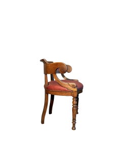 Late 19th-century walnut armchair with turned legs and red leather upholstery.