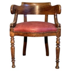 Late 19th-century walnut armchair with turned legs and red leather upholstery.