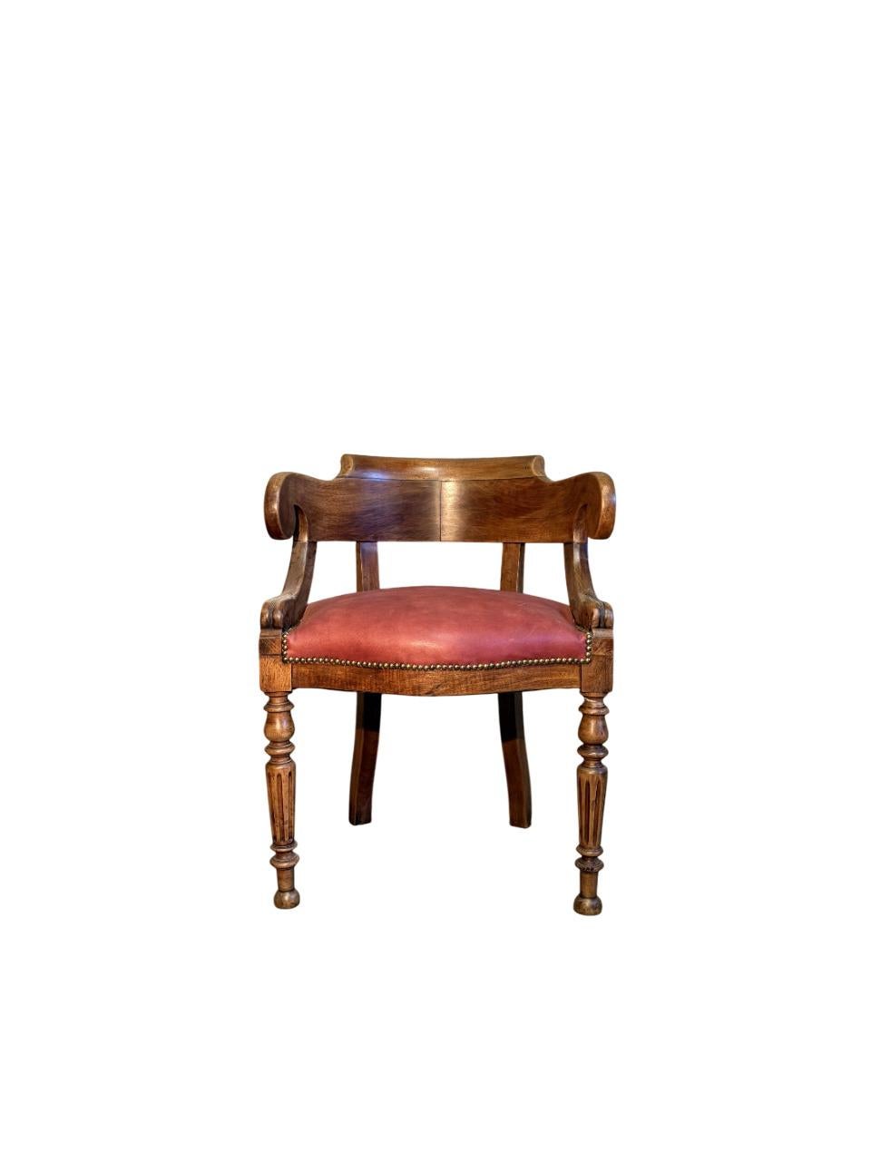 Late 19th-century walnut armchair with turned legs and red leather upholstery.