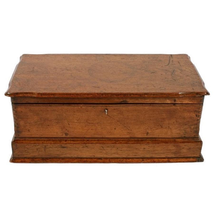 A late 19th century Victorian walnut deed box.

The oblong box has a hinged lid with a shaped edge and a deep plinth base with a moulded bottom edge.

The box has a lock and key but it does not work.

The box is in original condition with a