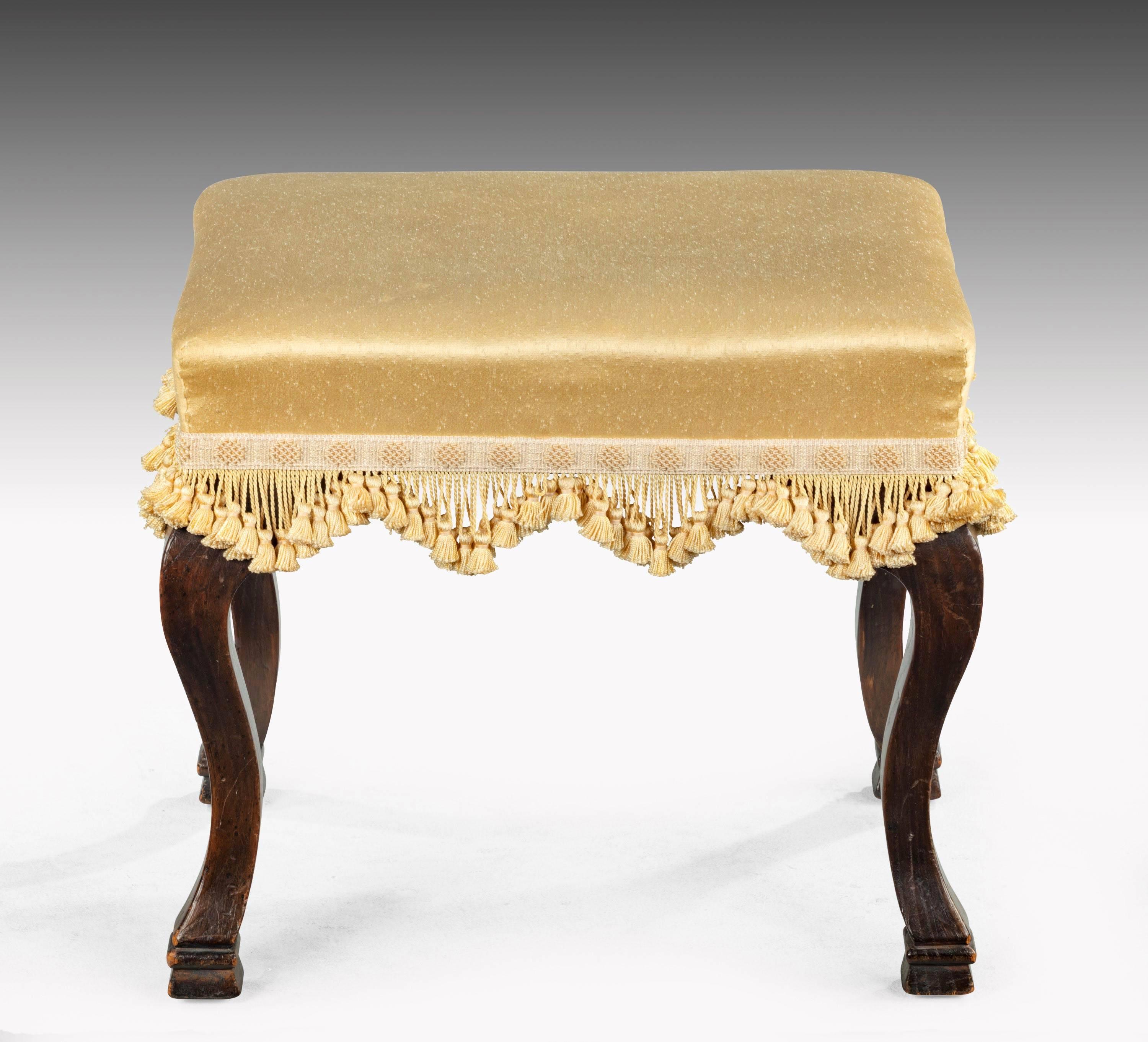 A late 19th century well-formed footstool on light cabriole legs.