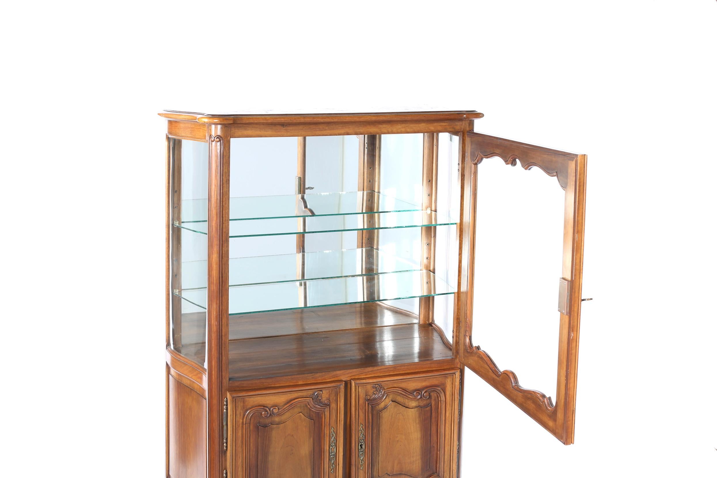 Late 19th century walnut with mirrored interior and glass shelving with front bottom doors China cabinet or hutch. The cabinet is in good antique condition with appropriate wear consistent with age or use. The cabinet stand about 56 inches high x 39