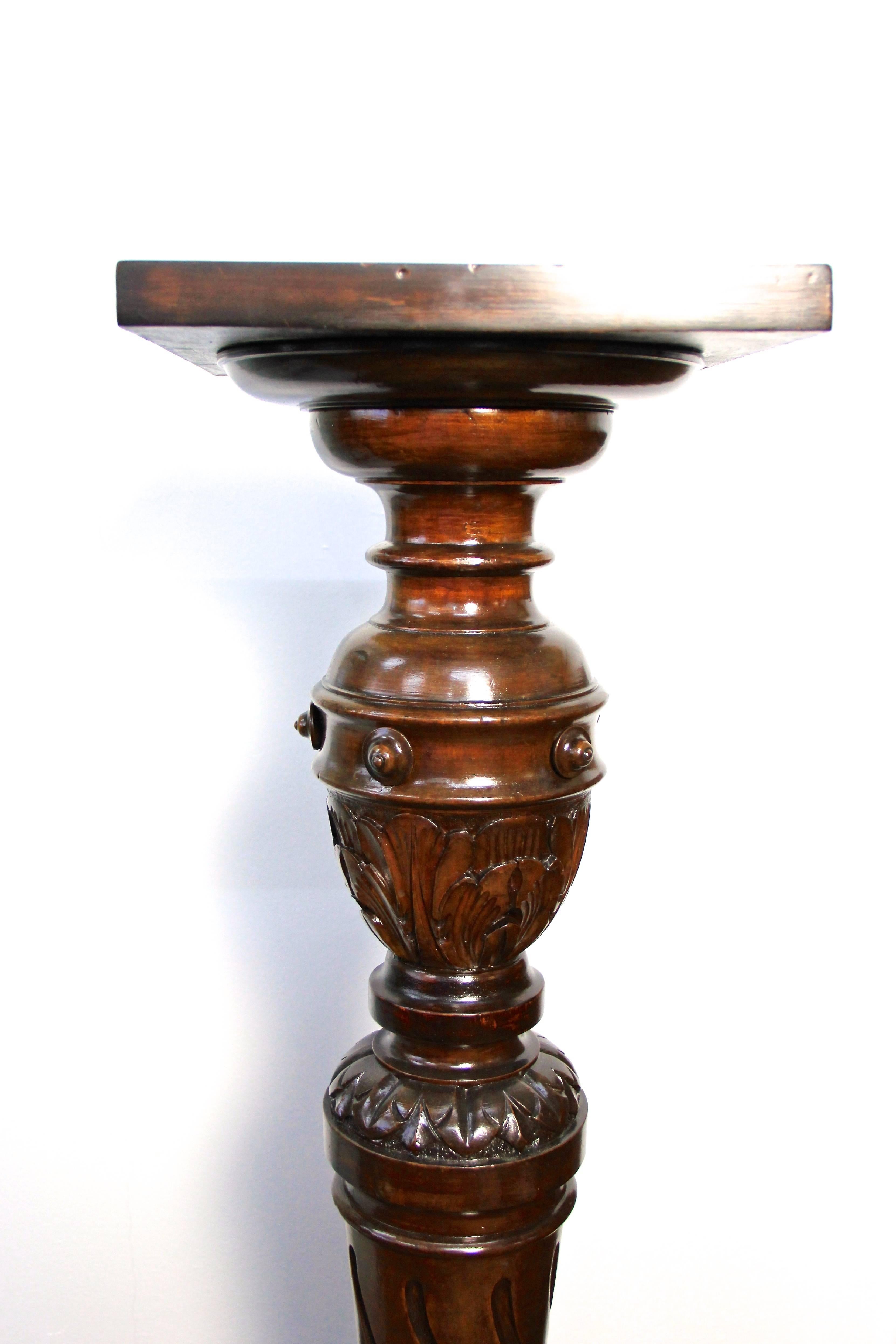 Lovely late 19th century Walnut Pedestal from circa 1870 with classy design. Elaborately hand carved out of solid nut wood, this beautiful Austrian column/ pedestal impresses with a fantastic design: adorned by floral elements, the elaborate made