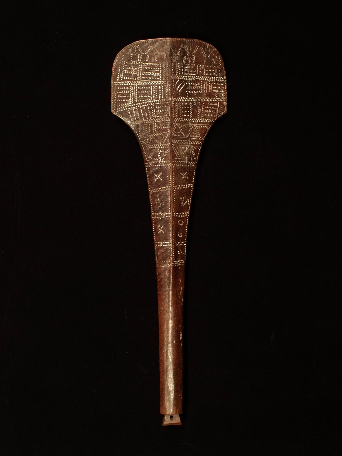 Late 19th Century Fa’alautalinga War Club, Samoa

A short cylindrical handle flares and flattens into a paddle form tapering to an edge, with a raised medial ridge on both sides. Finely carved zigzag motifs cover the surface except on the handle,