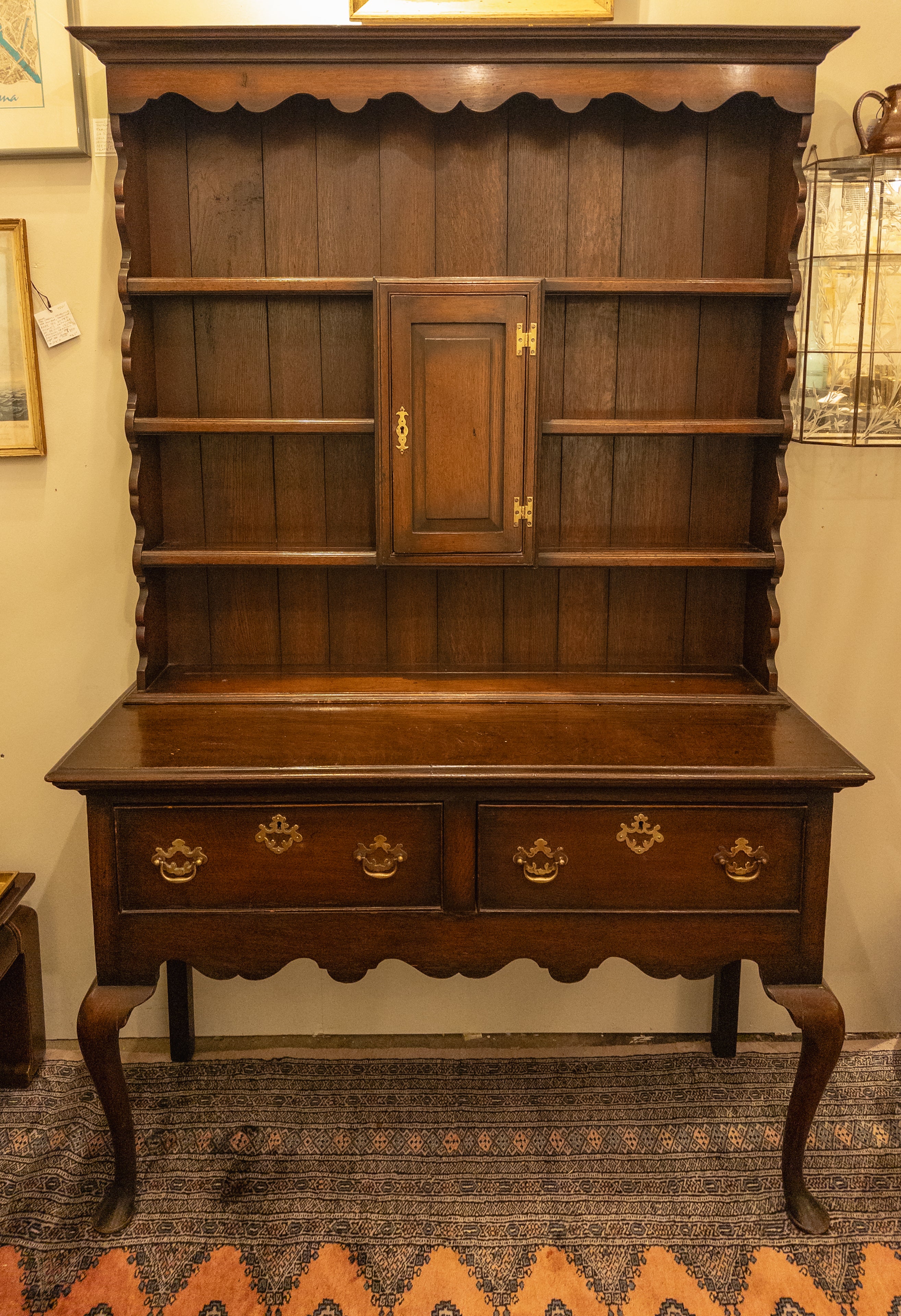 The late 19th-century Welsh Cupboard, fashioned from British Oak, is a captivating embodiment of historical craftsmanship. Adorned with a striking and authentic patina, it exudes a timeless allure that reflects the passage of time. The piece is