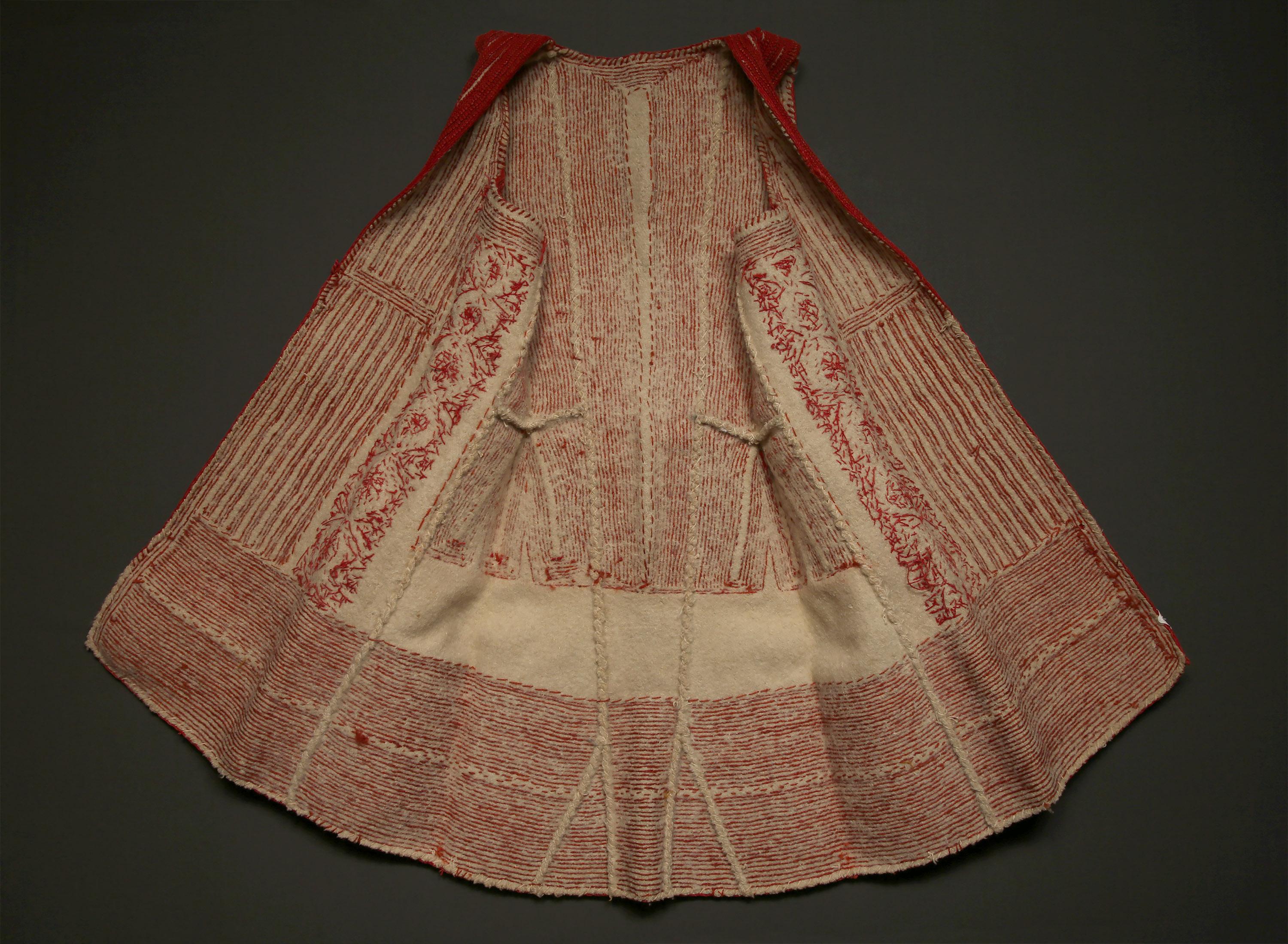 Late 19th century woman's waist coat, Macedonia

A traditional young bride’s vest, fitted at shoulders with flare at hips. It creates a visual statement of intricate simplicity. Felted natural wool with embroidered thick red wool and natural
