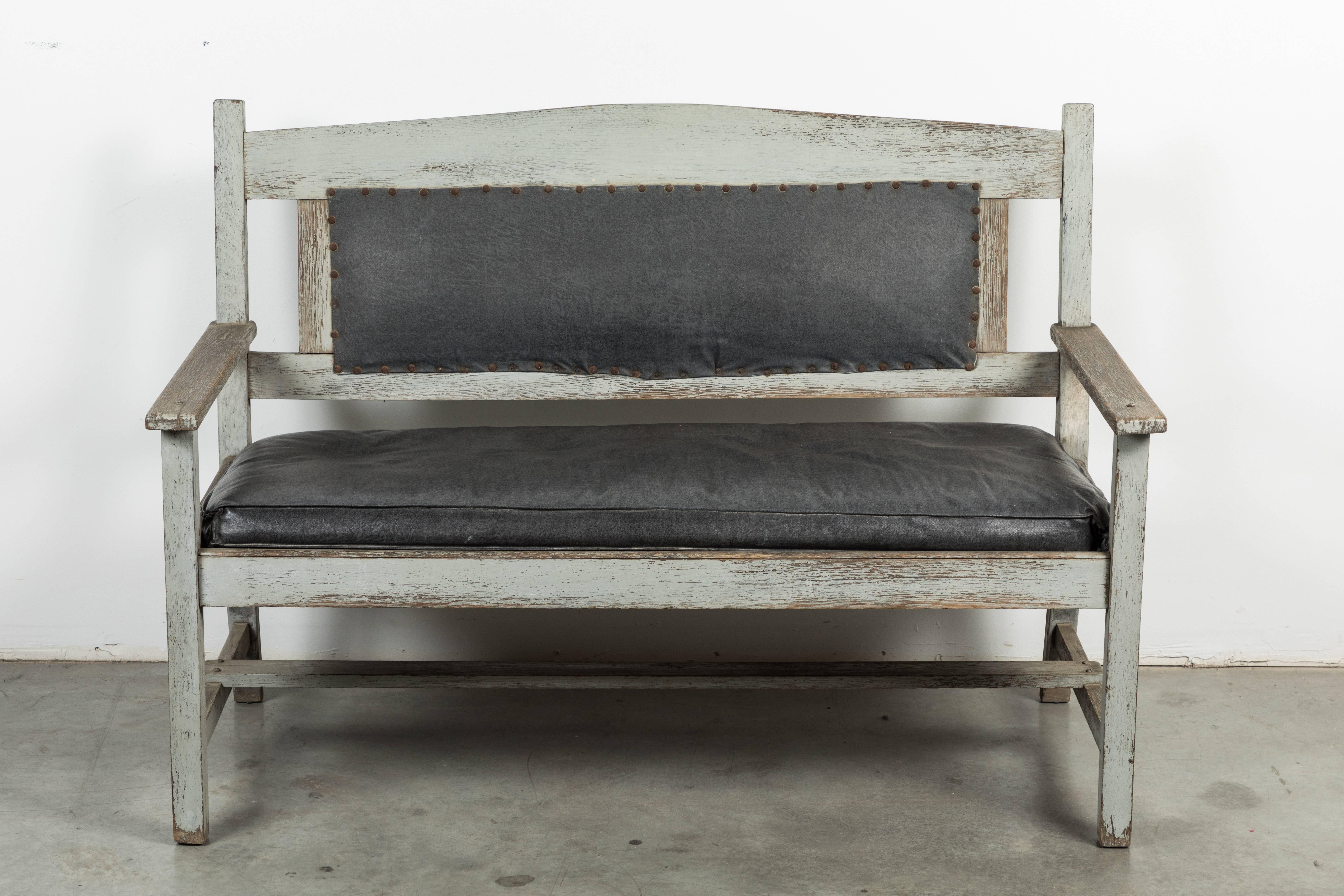 Great looking late 19th century railroad station bench found in the mid-west. Original grey paint on wood surface and very nicely aged leather seat and seat back. Solid and sturdy.