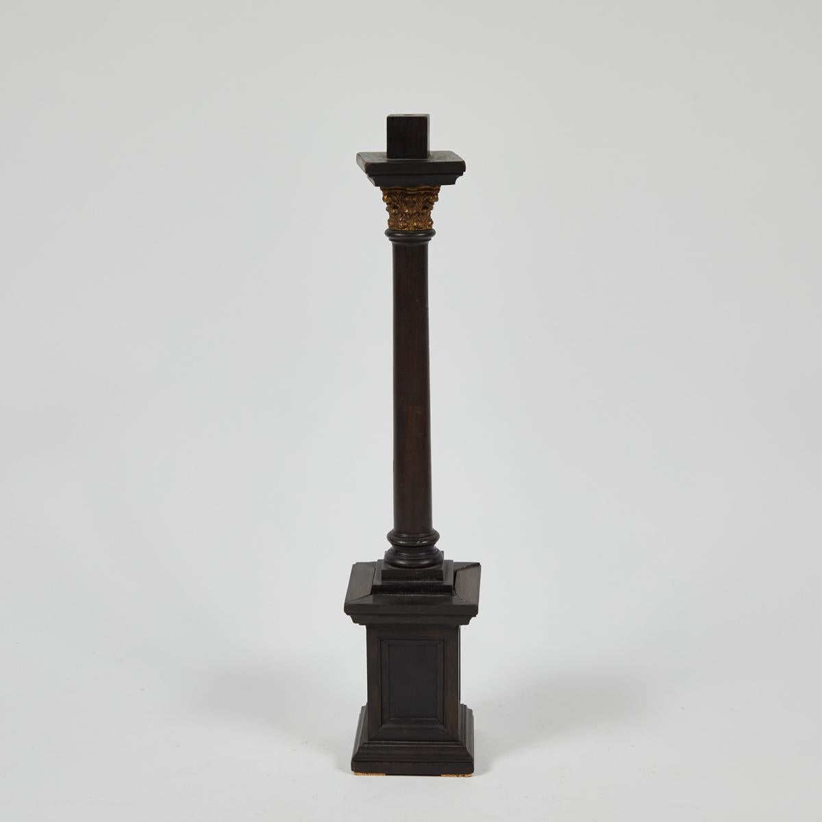 Late 19th-century neoclassical wooden column model from France. Exceptional handiwork has gone into this creation; the gilded Corinthian capital has been minutely carved and makes a wonderful contrast with the dark, smoothly buffed wood. An