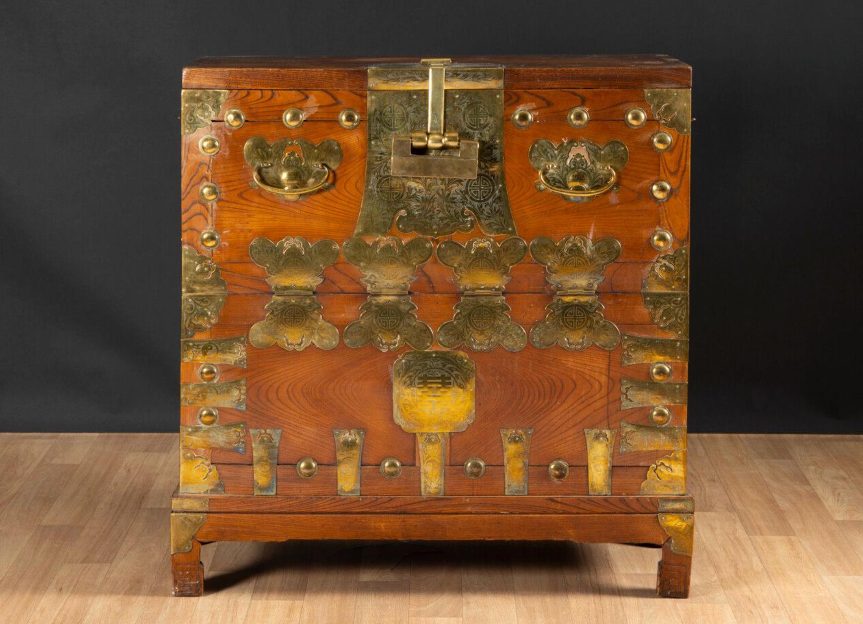 Chest in natural wood made in late 19th century and lately transformed into a secretary with red interior. The gilded brass fittings depicting stylized butterflies, finely chiseled with plant motifs and symbols of longevity. There is the original