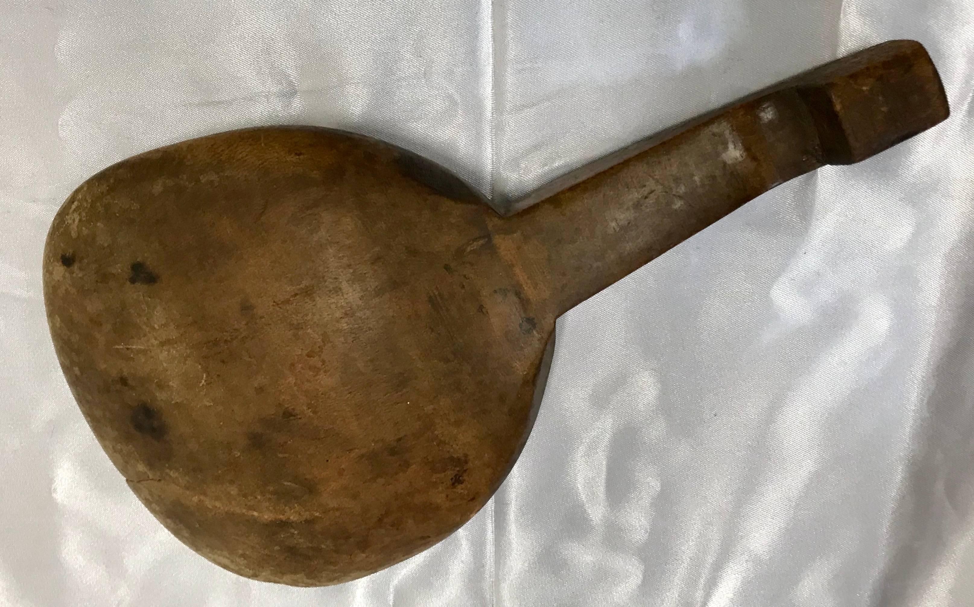 Featured is a spoon or paddle from France during the late 19th century. You can determine from the wear on the edge that it was used many times to give it a beautiful primitive patina. The handle boasts a lip on the end to easily hang it to the edge