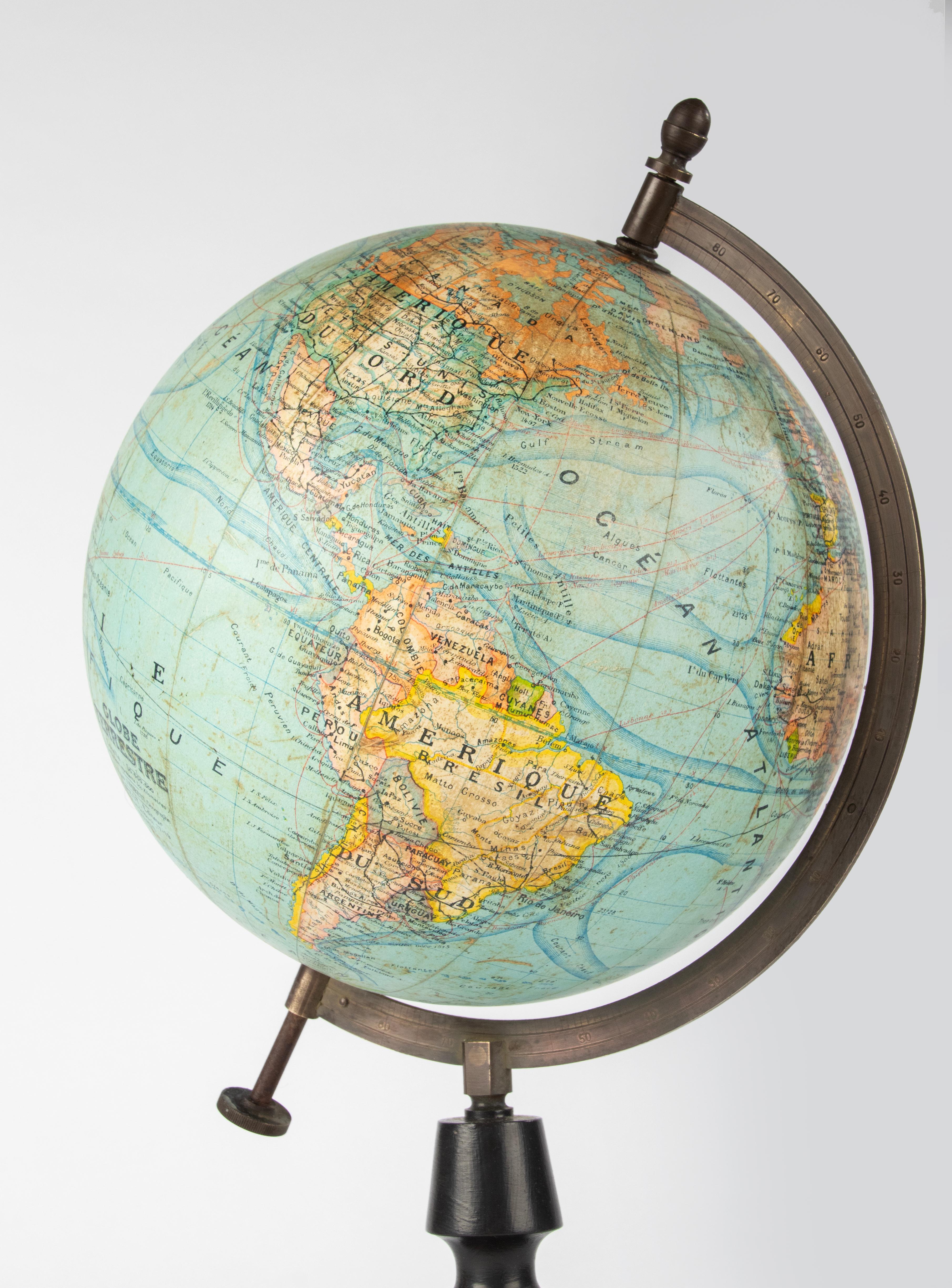 A beautiful antique world globe, made of cardboard and paper, on a blackened wooden stand. 
The globe was edited by J. Forest from Paris. The globe has a beautiful protractor, made of copper. 
Estimated date: circa 1900. 
The globe is in good
