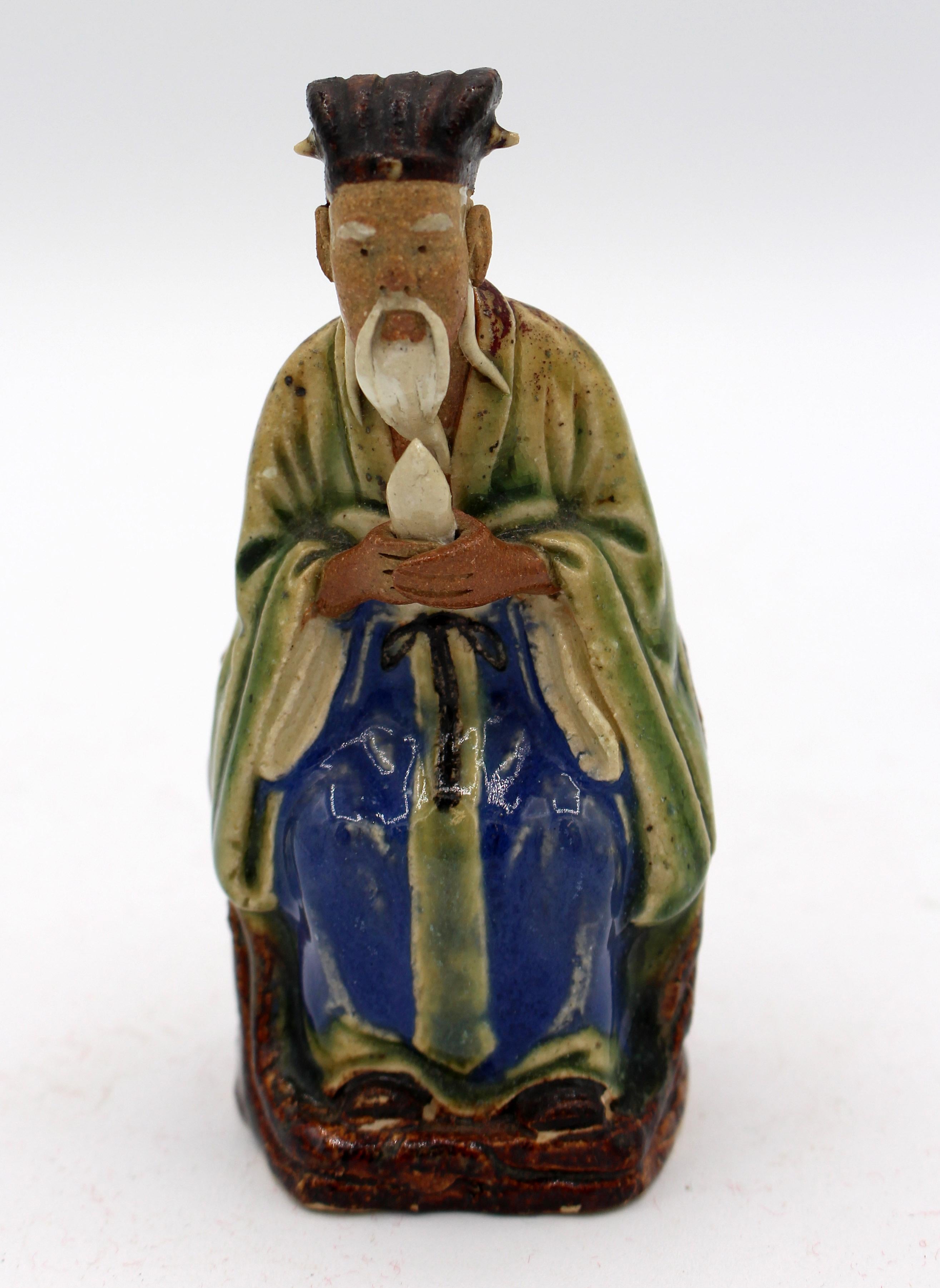 A fine Chinese mud man figure of a seated wise old man, c.1892-1904 (World's Fairs). The face is finely detailed, the colors subtle. Indecipherable impressed mark. Measures: 4 1/4