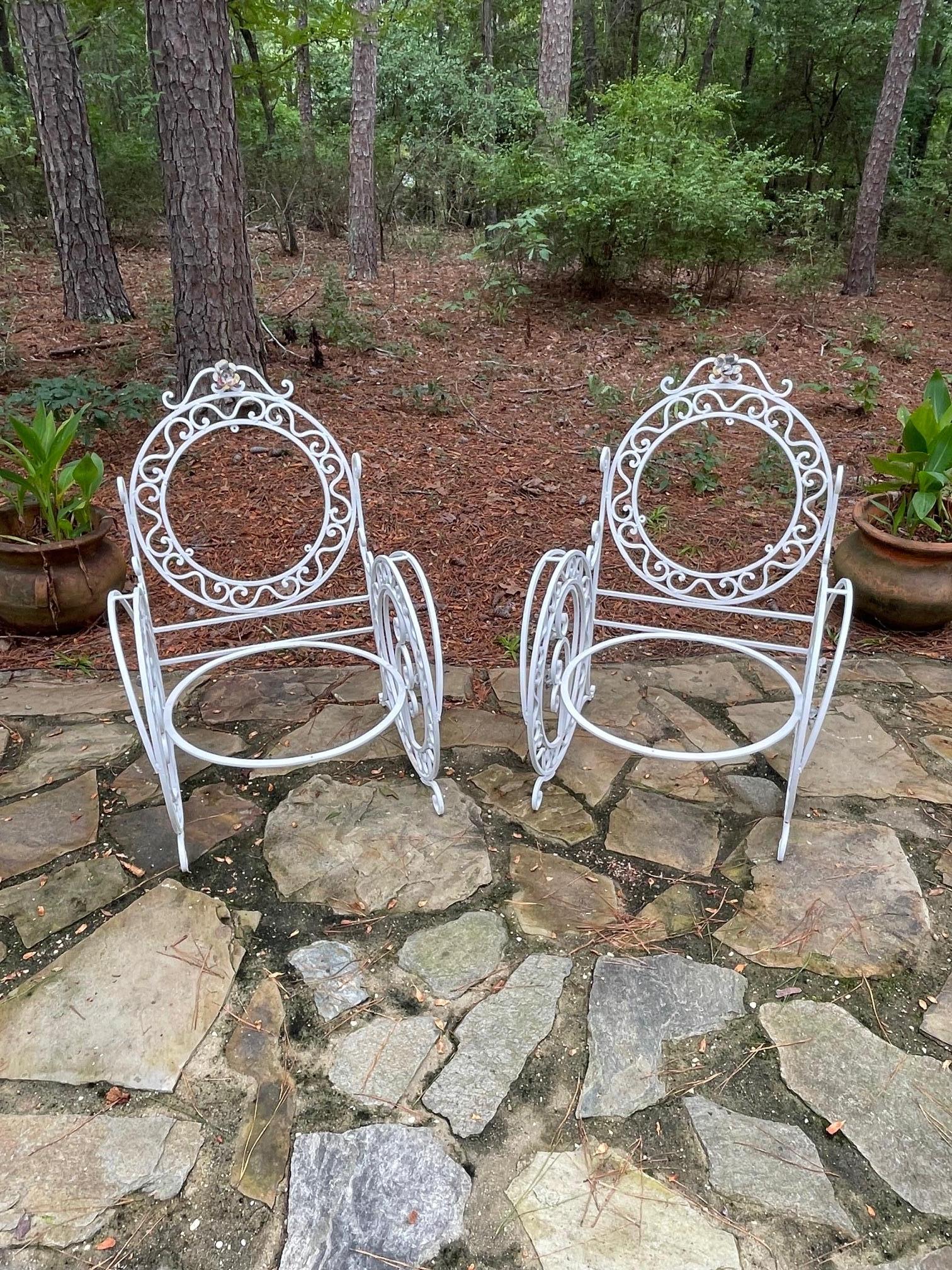 A quite exceptional late 19th century pair of French patio/orangery chairs.

This is a beautiful pair of large wrought iron chairs, with the most intricate decorative detailing and workmanship throughout. Exquisite flowers and leaves decorate the