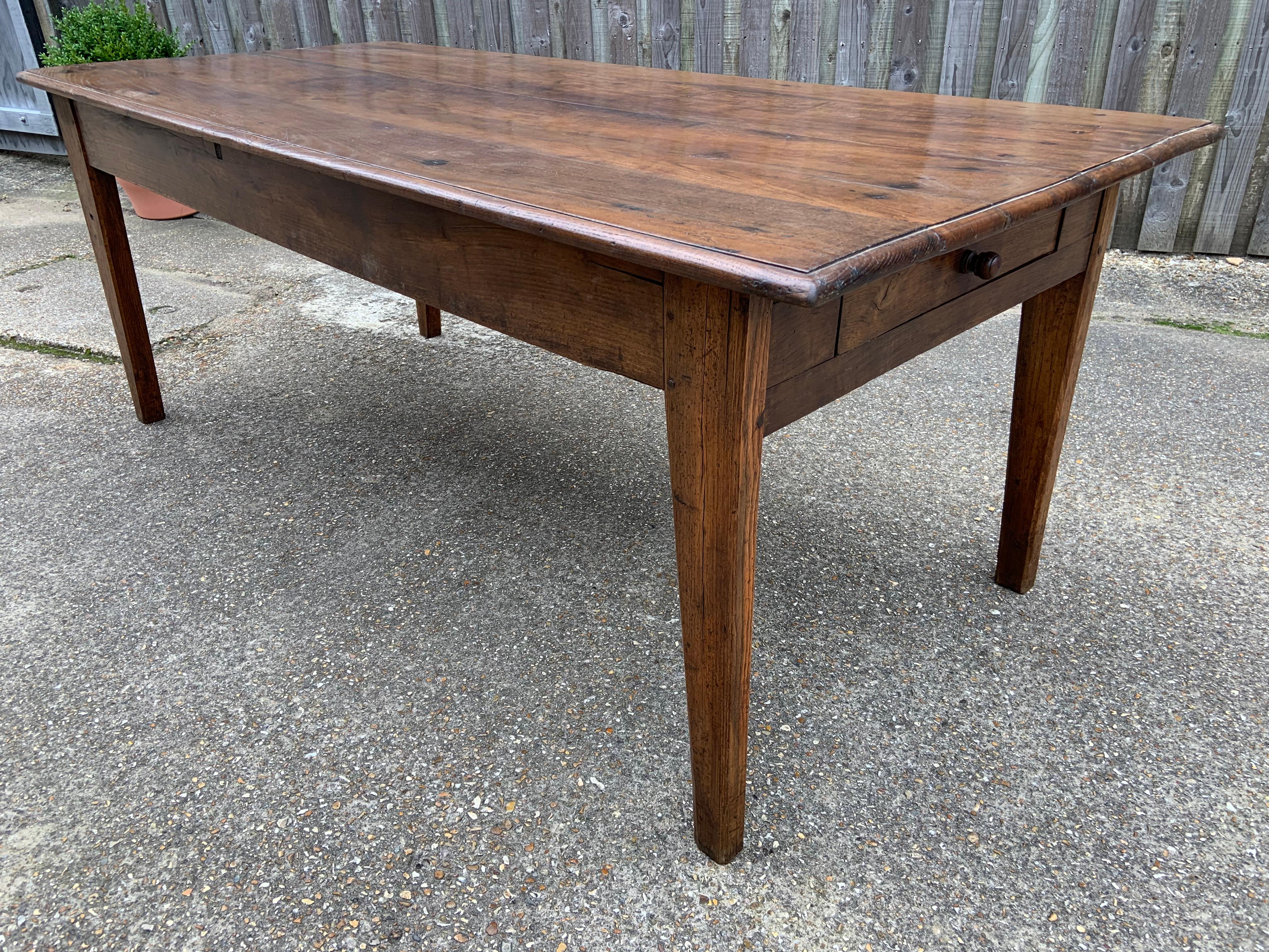 Late 19th Century chestnut farmhouse table with one drawer. Beautiful five plank top with tapered legs and end drawer.

 