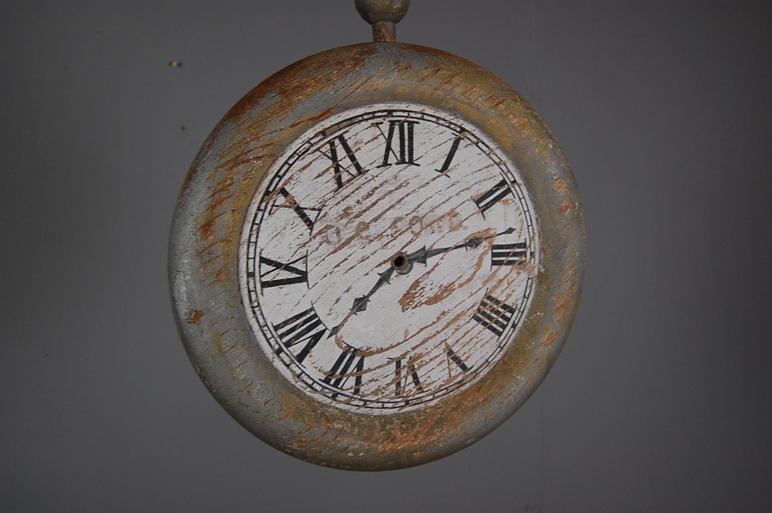 Late 19th or Early 20th century English watchmakers trade sign, would have hung to the exterior of a watchmakers store. Solid wood (pine) in the form of a pocket watch with heavily weathered crusty painted surface, remnant gilding with heavy