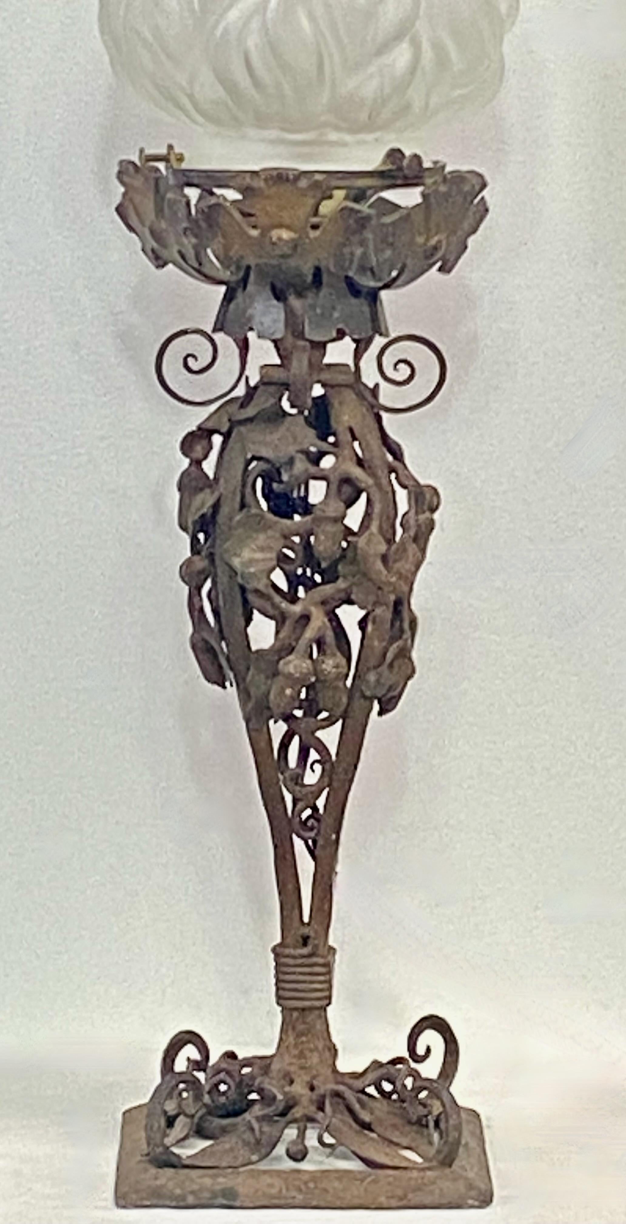 An exceptional wrought iron lamp base. We believe this was probably a custom crafted gas newel post lamp originally. A considerable amount of skilled workmanship went into the iron work with an Art Nouveau design of acorns and oak leaves. The flame