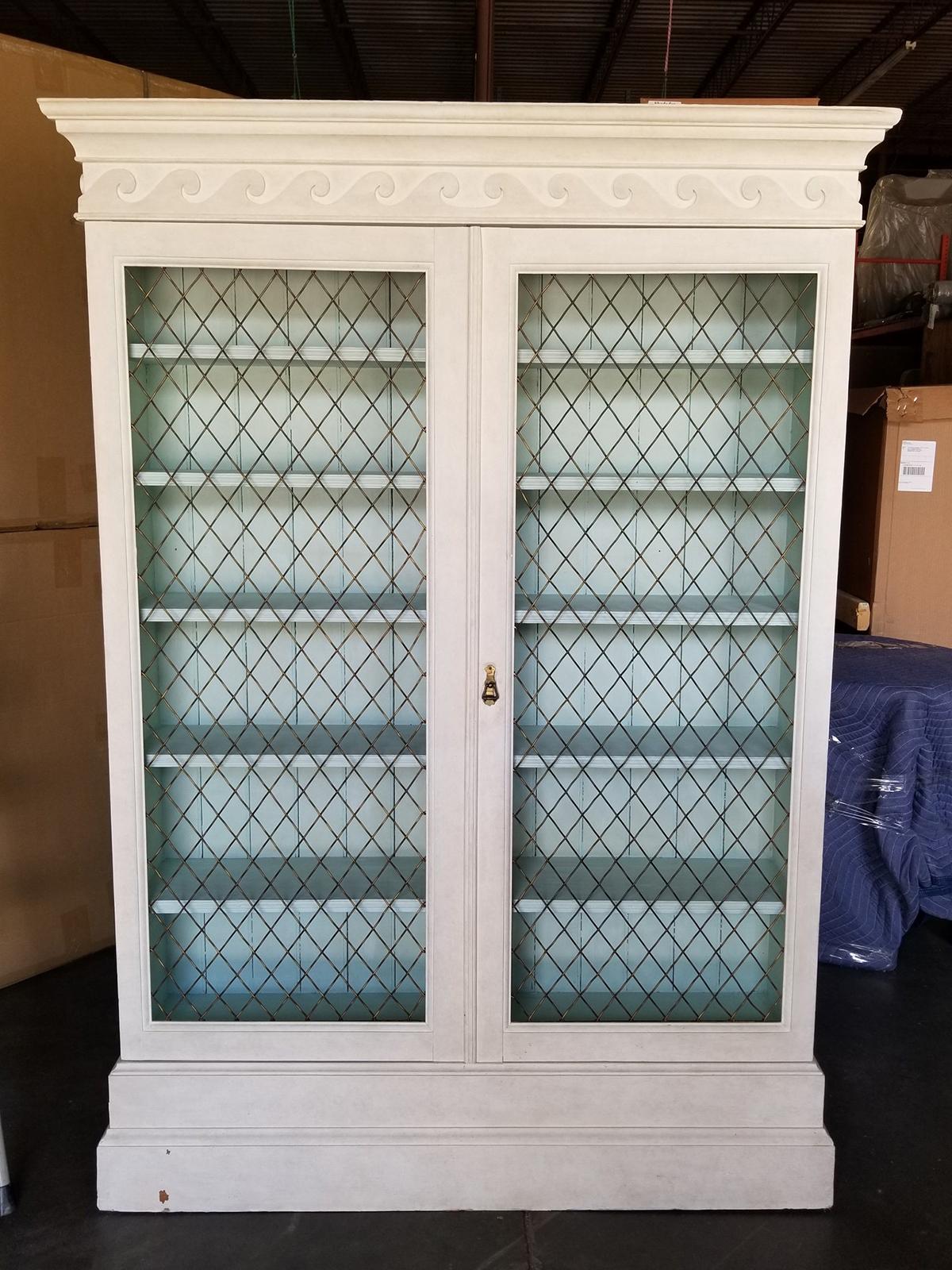 Late 19th-early 20th century George III style pine bookcase with bronze mesh doors and vitruvian scroll, custom hand painted finish.
Overall dimensions: 50.75