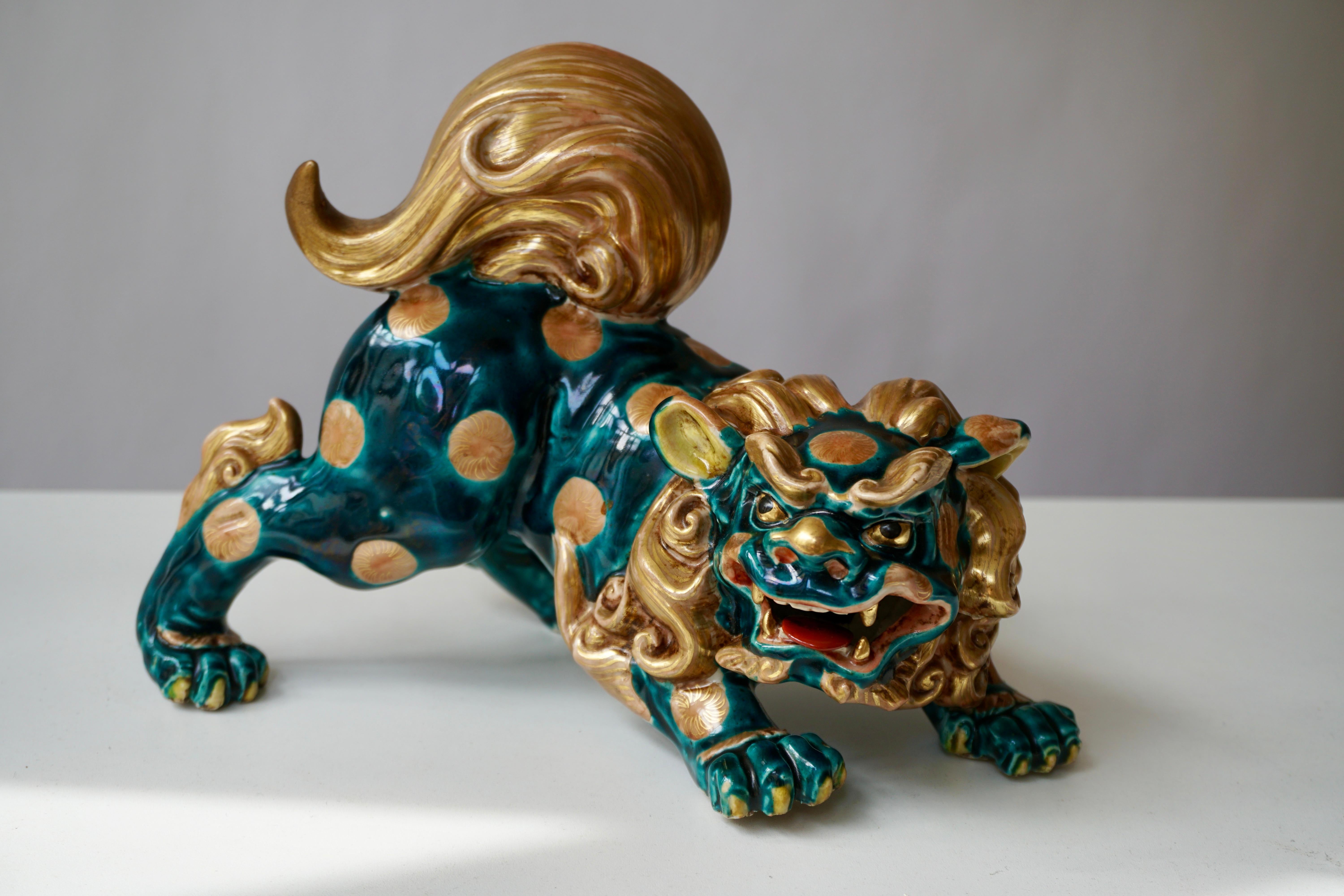 A painted Japanese porcelain sculpture representing the Foo dog. Features include incredible detail and expression with beautiful green and gold color.
Fu dog, foo dog or lion dog, or Chinese temple lion. Foo (Fu) means prosperity and good fortune