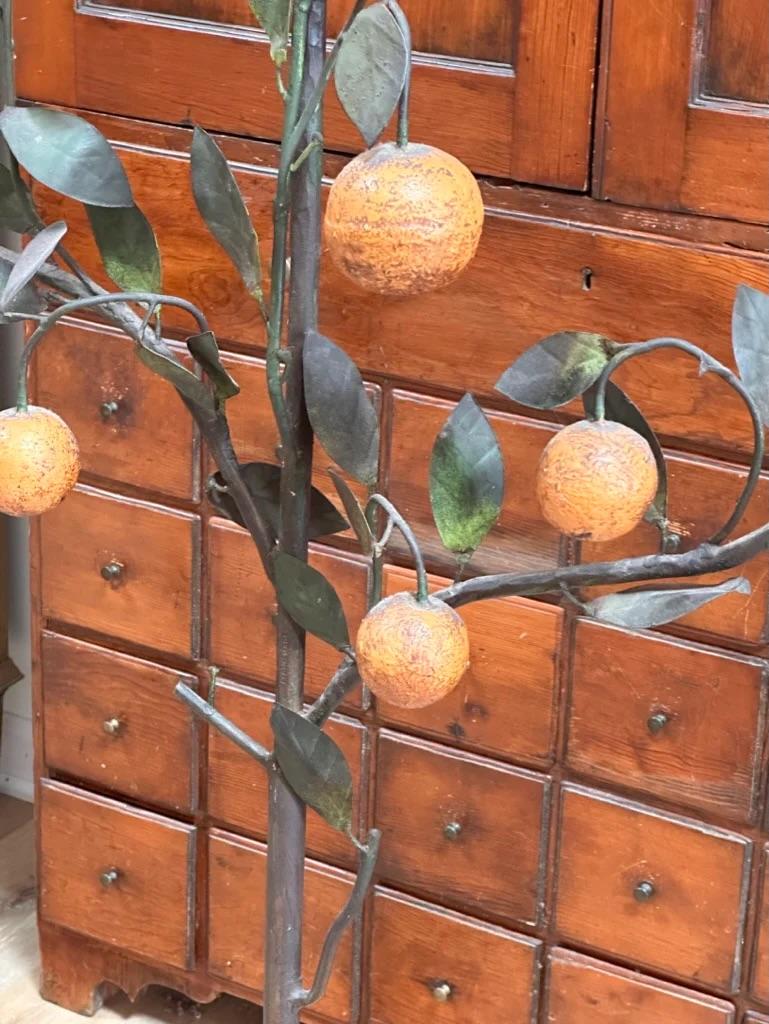 Late 19th – early 20th Century Italian Tole-Peinte Model of an Orange Tree.  Iron branches with leaves and 9 oranges, the trunk terminating in a and on five legs, ht. 65 in
