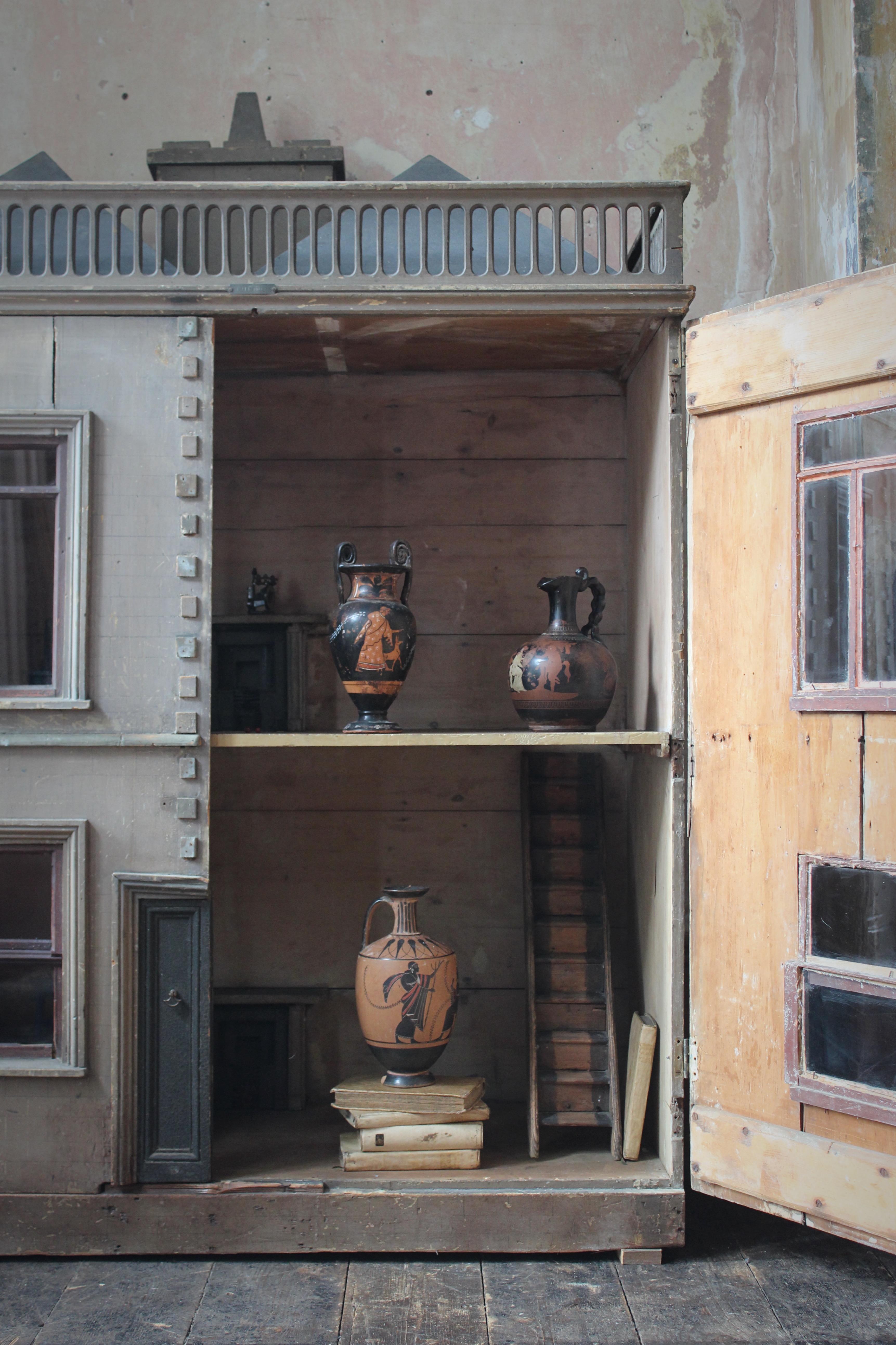 A decorative trio of country house grand tour attic ware vases, with typical red and black decoration.

Ranging in age from the late 19th to early 20th century, the lighter ground vessel has had extensive repairs, but is perfectly sound and